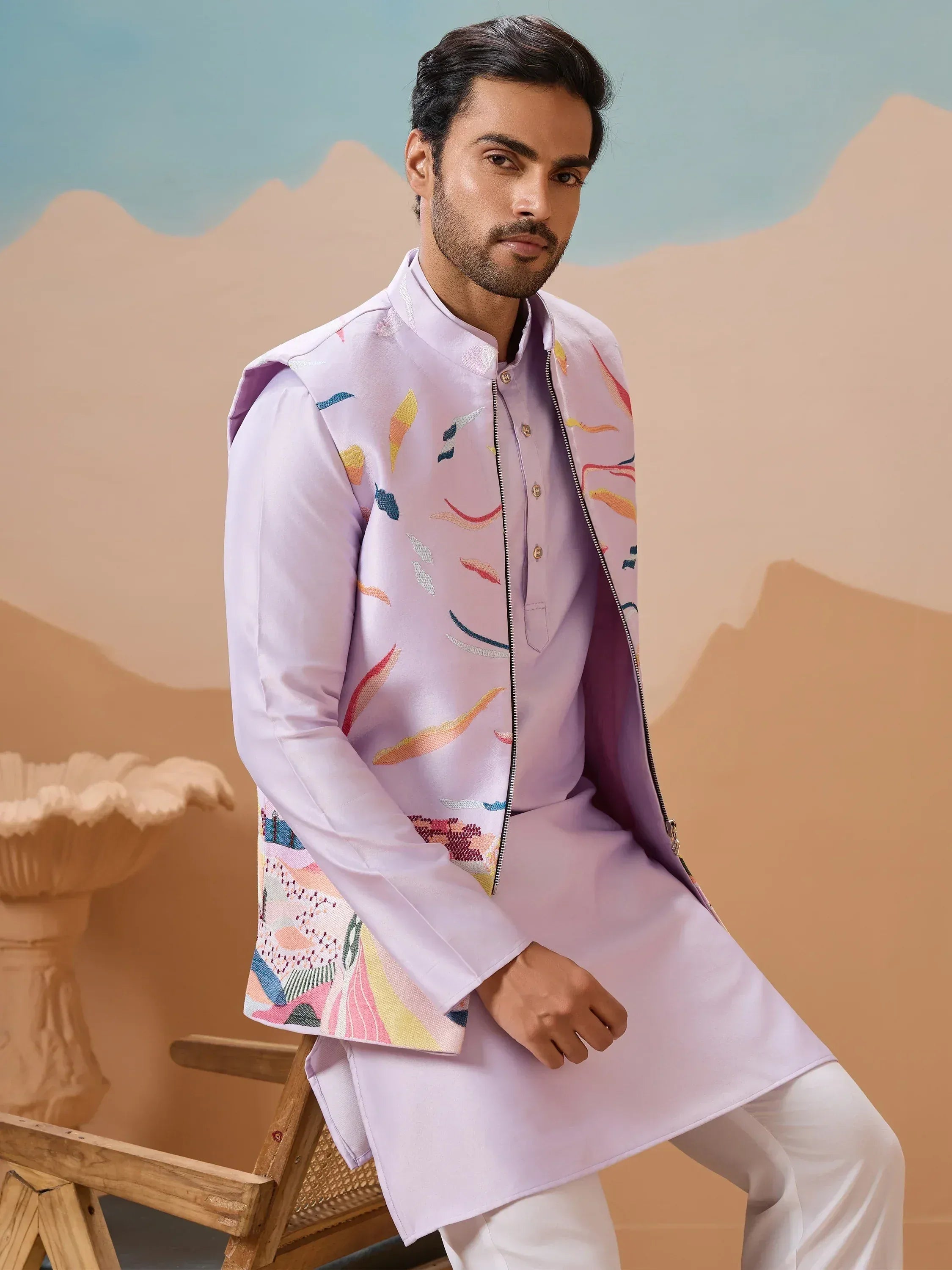 Man in lavender ethnic kurta with colorful embroidered jacket, ideal for Indian festive occasions