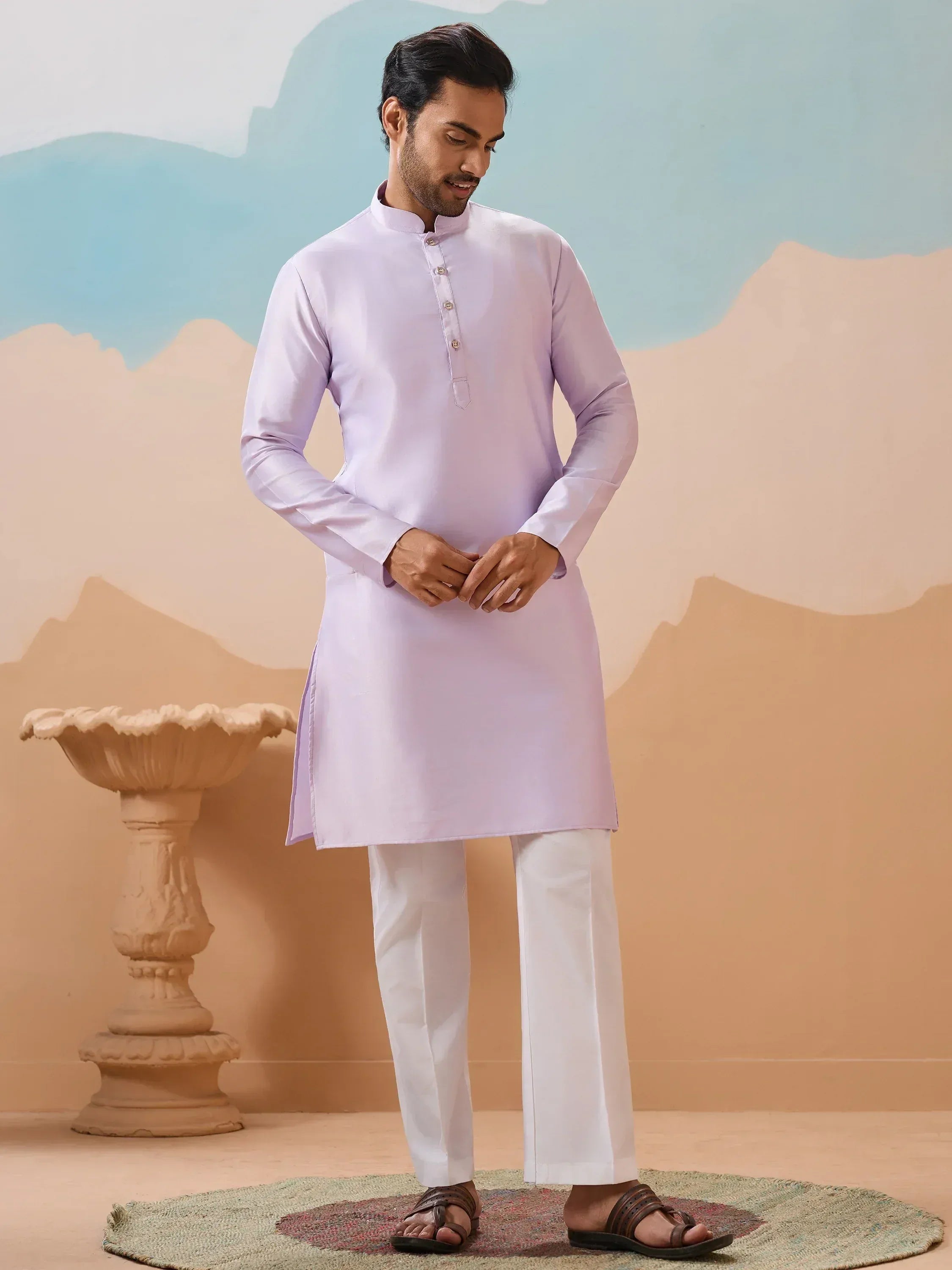 Man wearing light purple kurta with white pants, traditional Indian ethnic wear for men