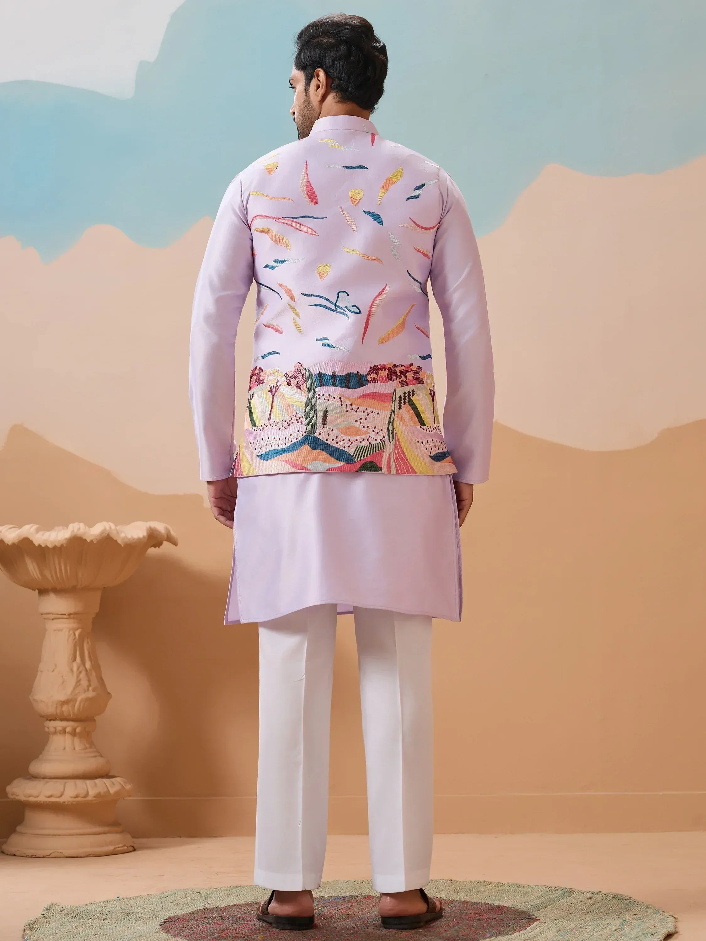Man in light purple embroidered kurta set with colorful abstract back print, white pants, ethnic wear