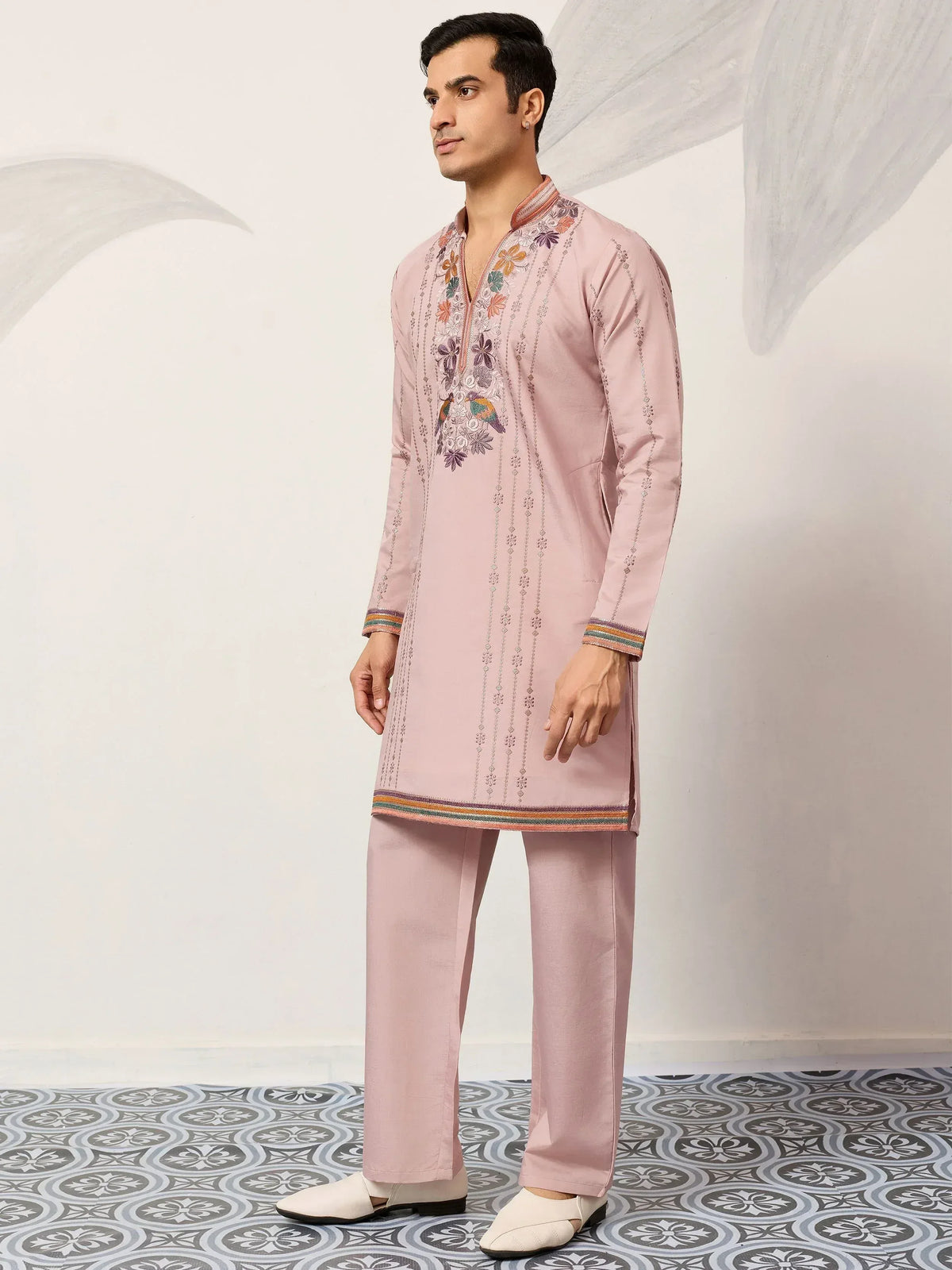 Pink embroidered kurta set with floral and bird motifs, paired with matching pants for ethnic wear.
