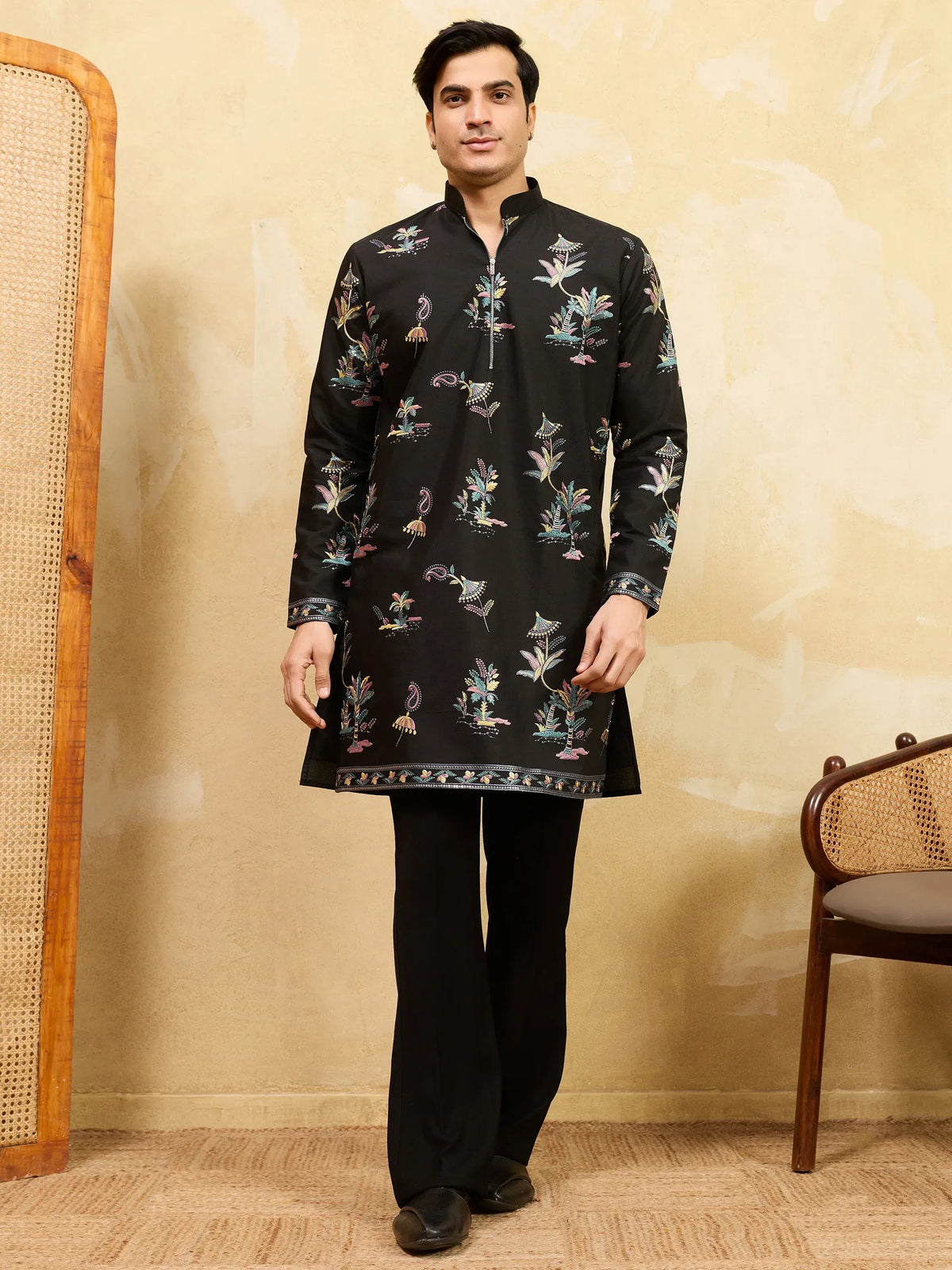 Man wearing a black floral printed ethnic kurta with matching trousers