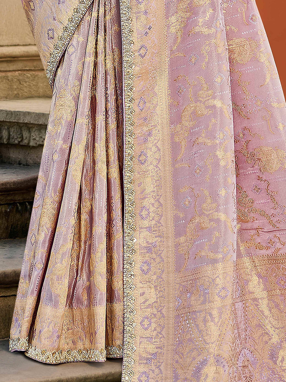 Pink and gold embroidered lehenga with intricate floral patterns and detailed border, perfect for Indian ethnic wear.