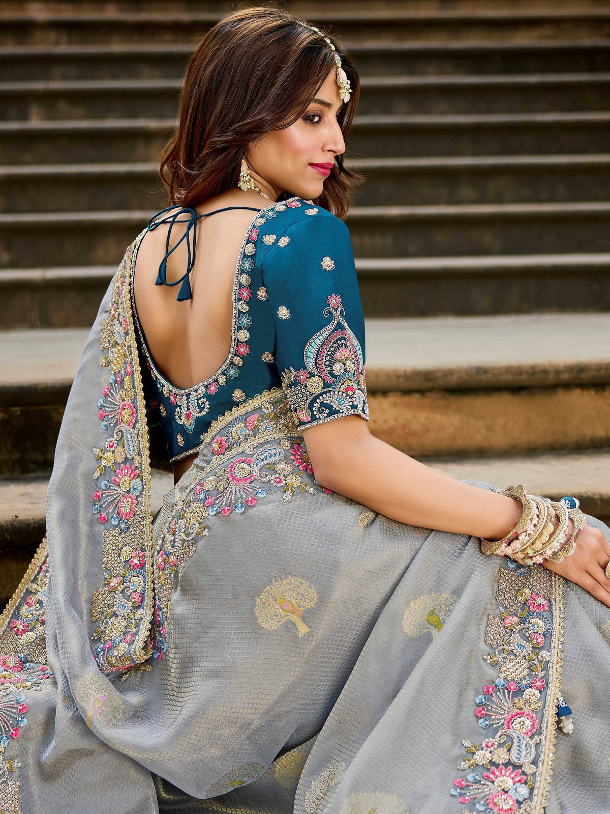 Grey and teal embroidered lehenga choli with floral motifs and open back design