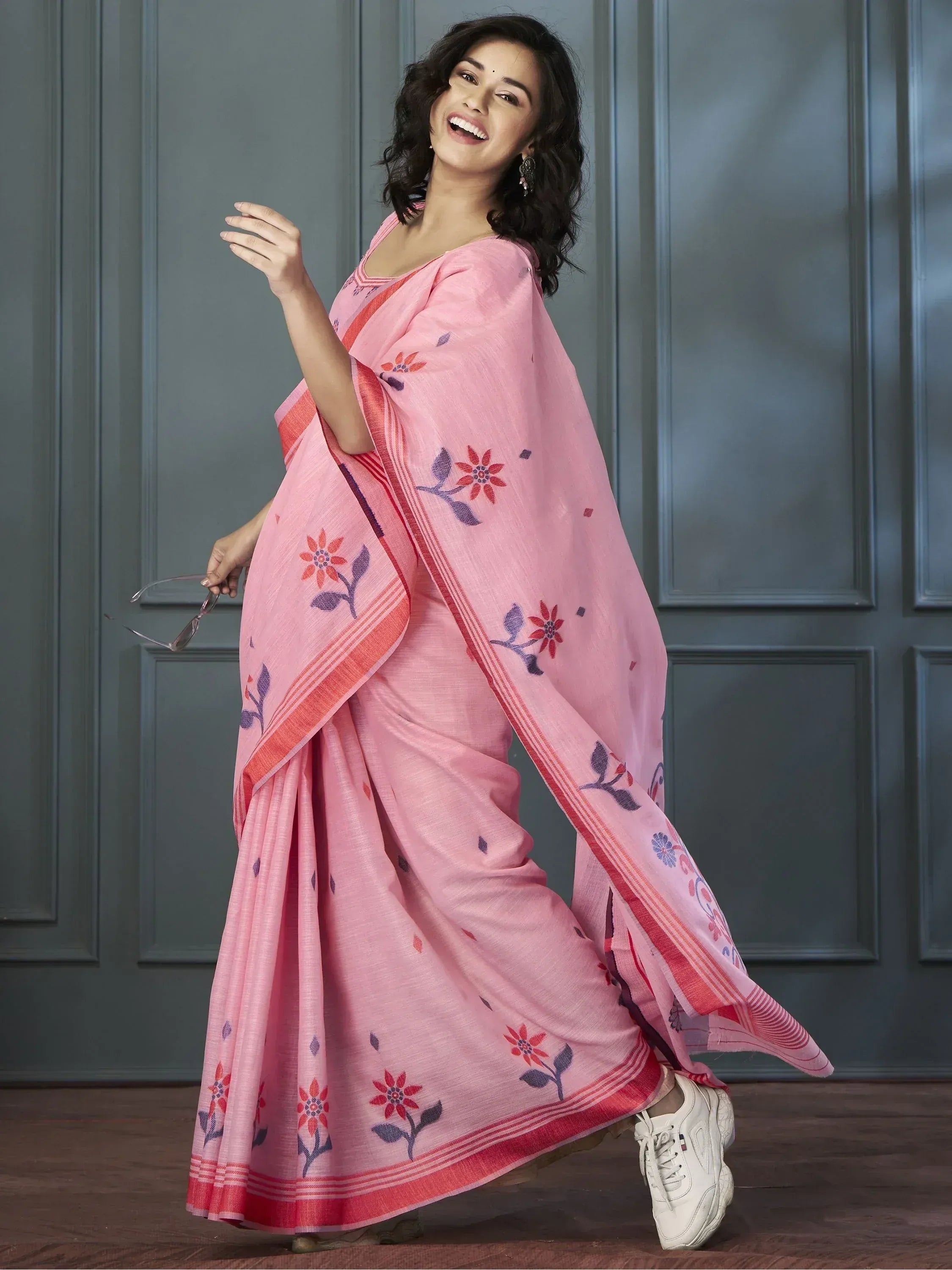 Pink floral printed saree with red border, styled with white sneakers for casual ethnic wear