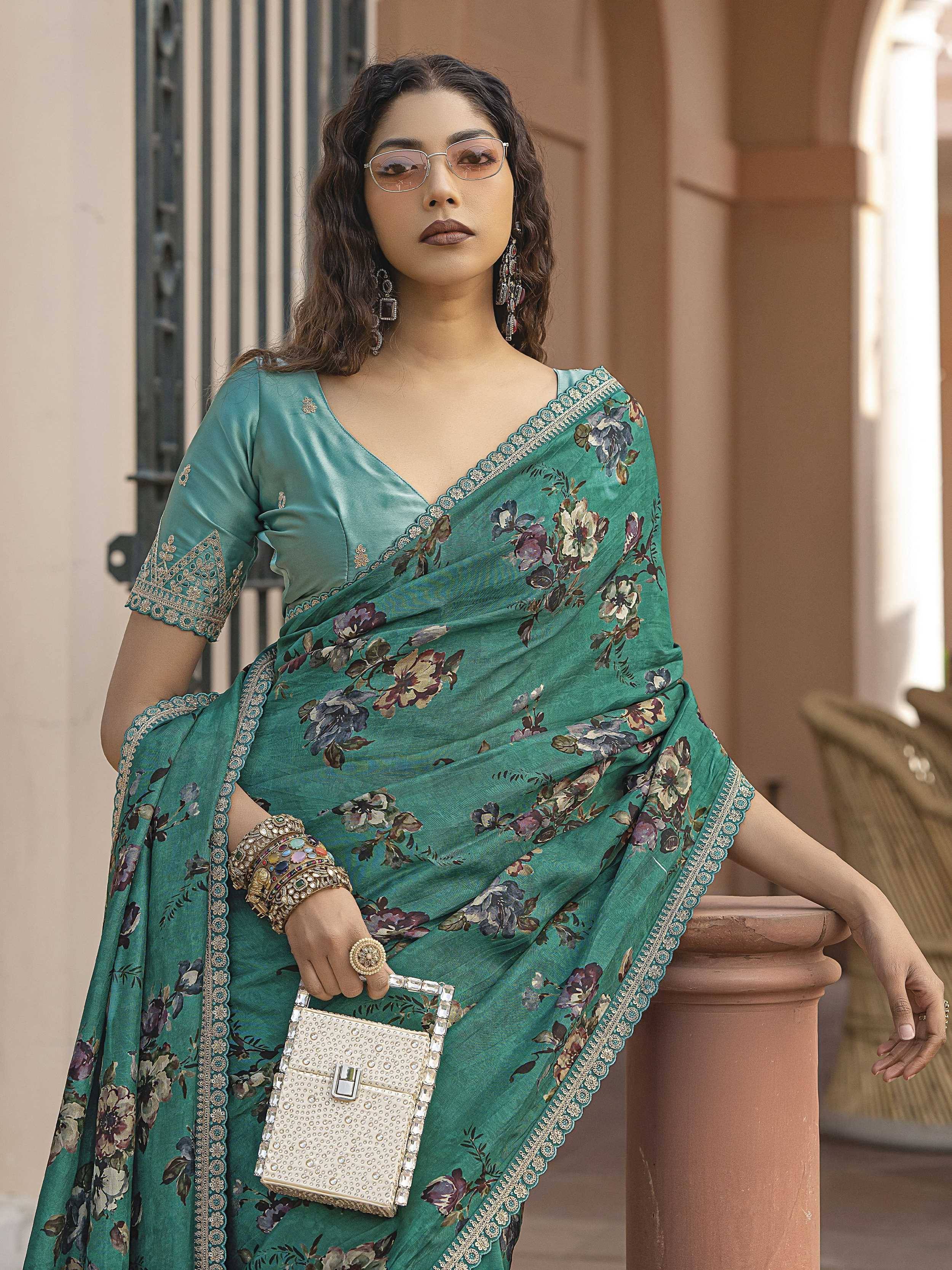 Teal floral saree with gold embroidery, styled with statement jewelry and a beaded clutch for ethnic wear