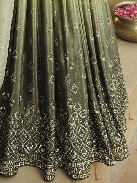 Olive green ethnic lehenga with gold mirror work and geometric embroidery, perfect for Indian weddings and festivals.