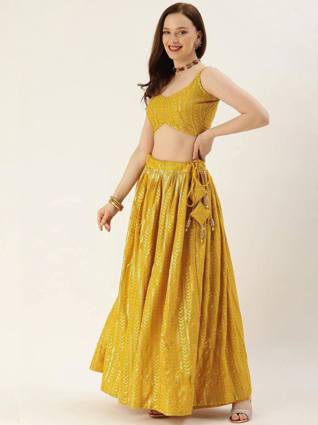 Yellow embroidered lehenga choli with crop top and flared skirt, perfect for Indian ethnic occasions