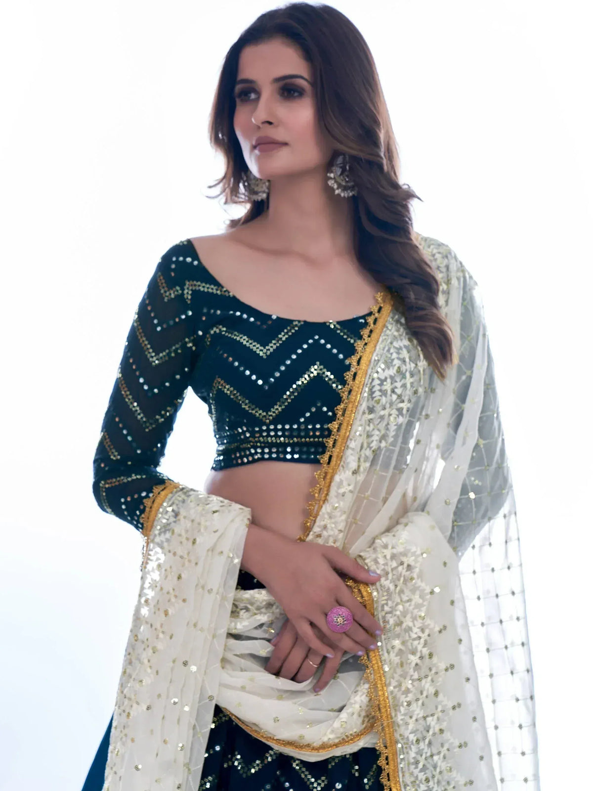Elegant black and gold sequin lehenga choli with sheer white dupatta, perfect for Indian ethnic wear occasions.
