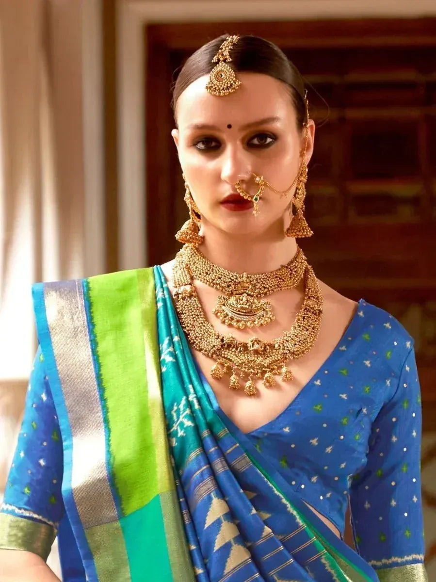 Blue and green ethnic saree with gold jewelry, perfect for Indian weddings and festive occasions