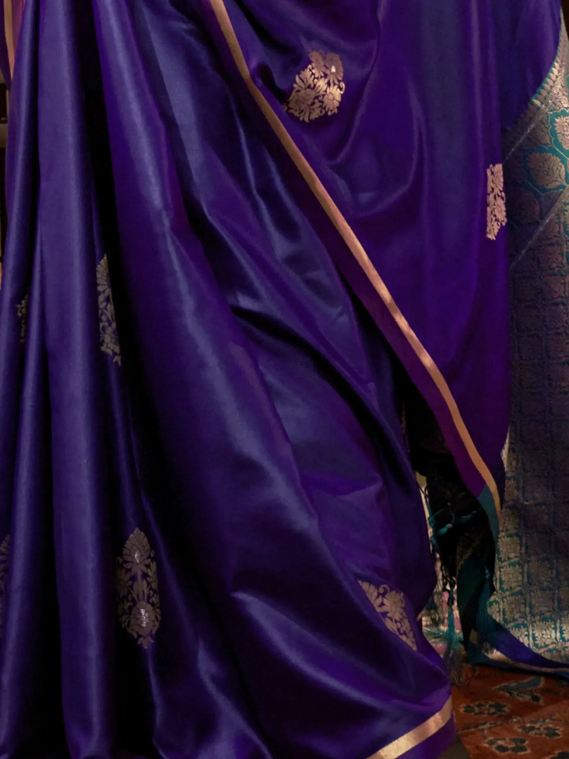 Purple silk saree with gold floral embroidery and border, ideal for ethnic occasions