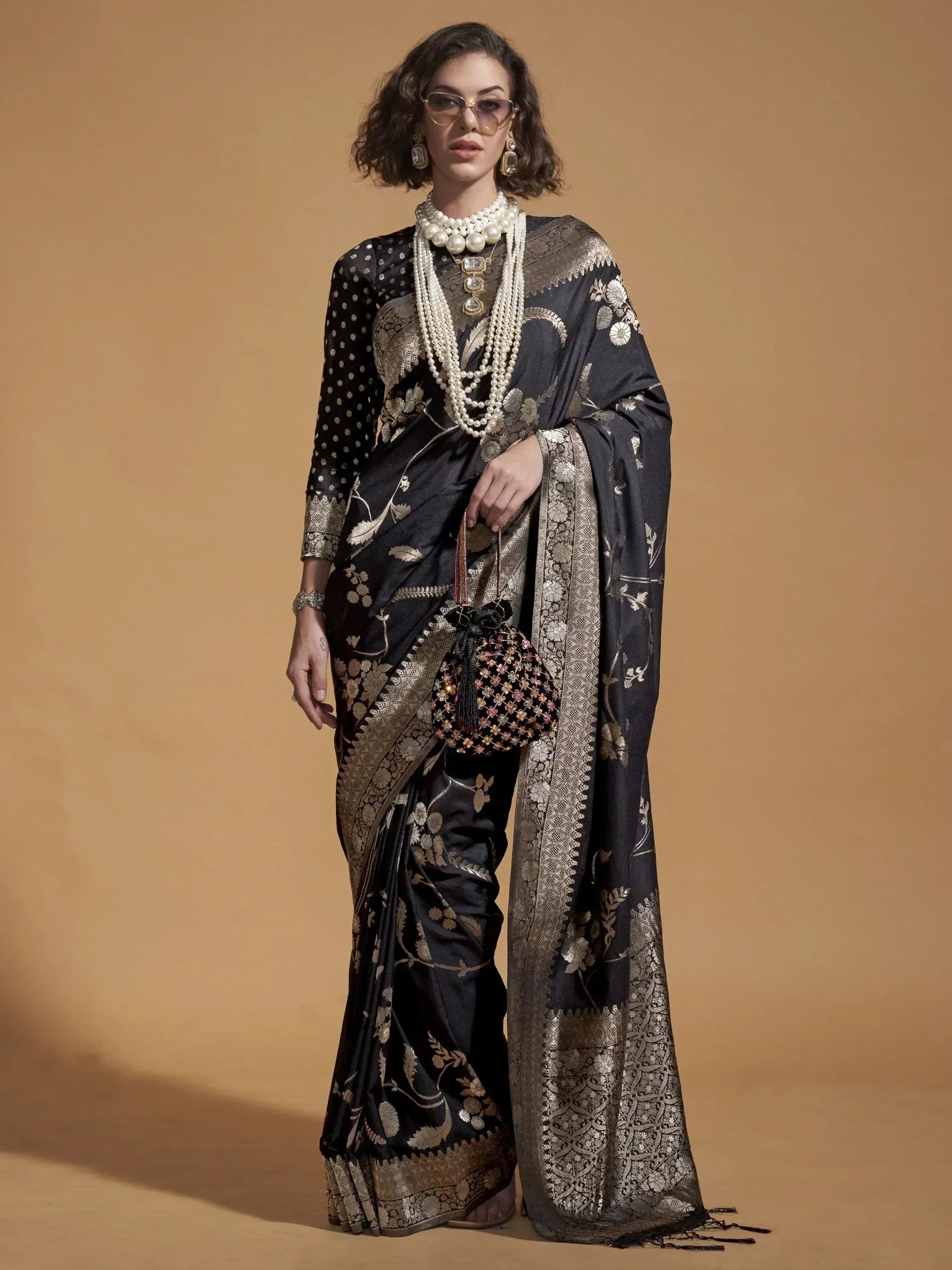 Black and gold floral embroidered saree with matching blouse, perfect for Indian ethnic wear occasions.