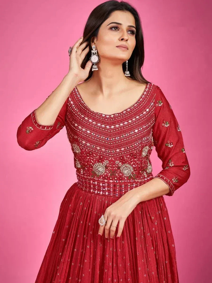Red embroidered ethnic gown with mirror work, perfect for Indian weddings and festive occasions