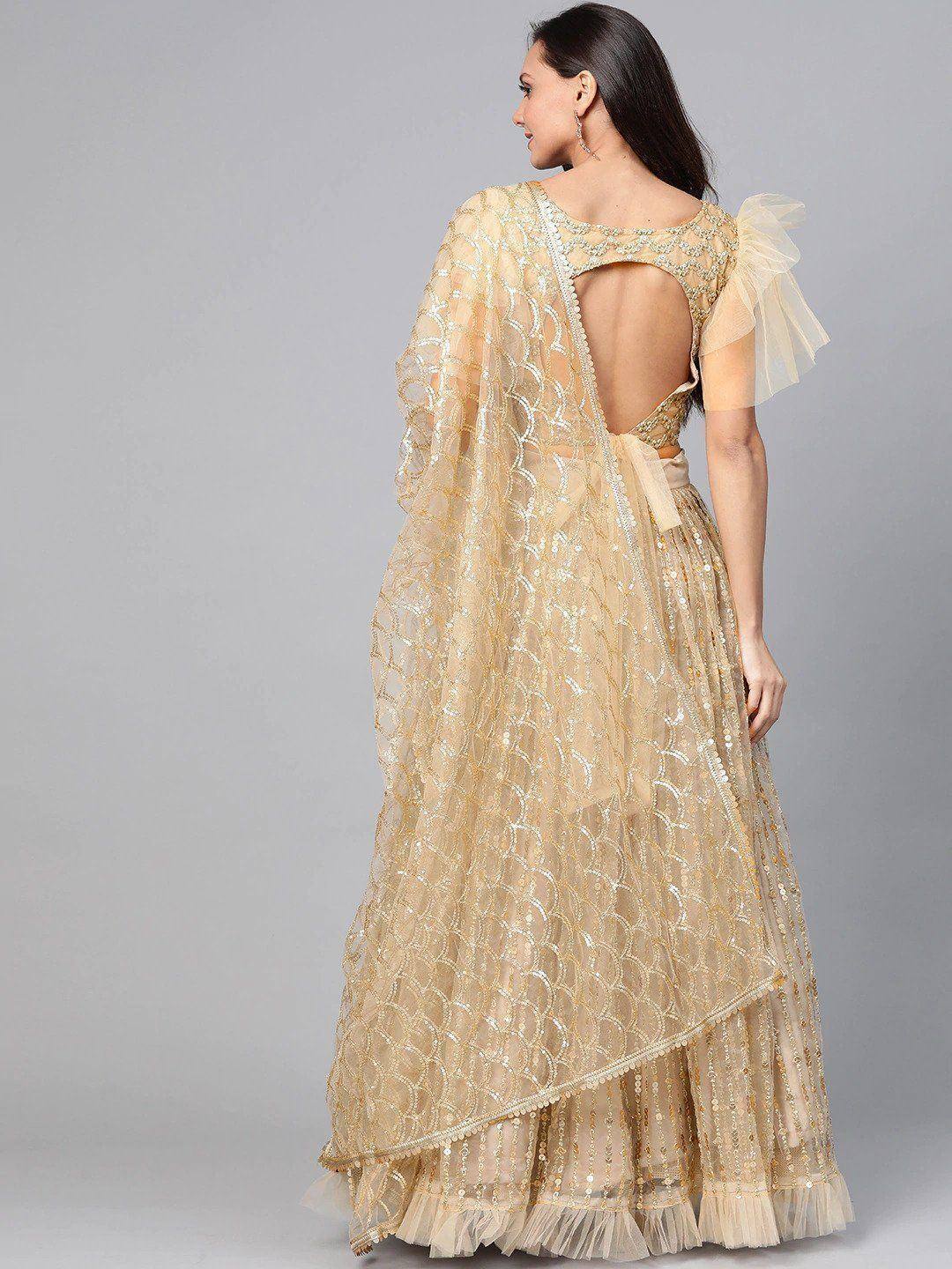 Gold sequin lehenga choli with backless blouse and sheer dupatta, ethnic Indian wear