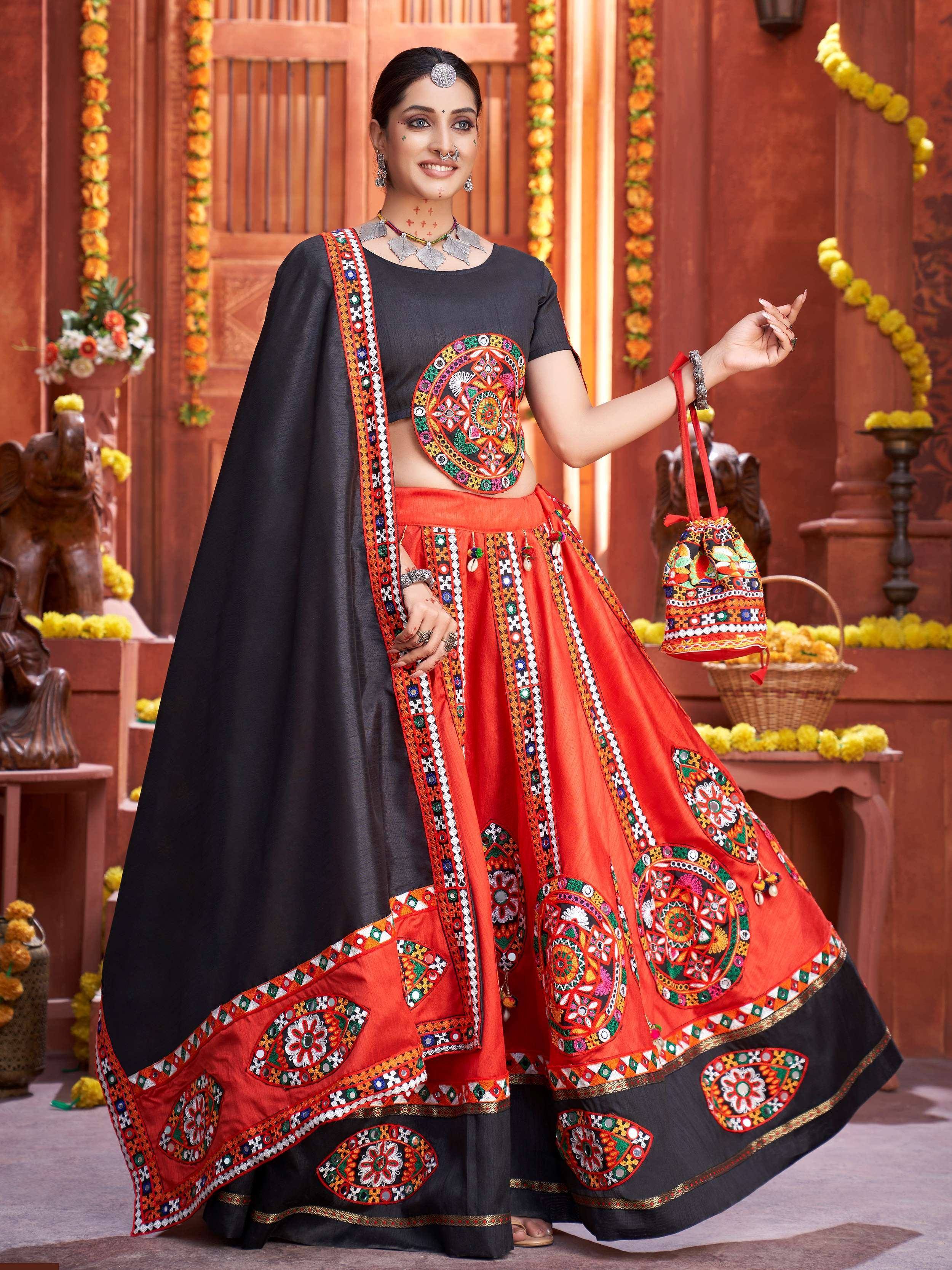 Black and orange embroidered lehenga choli with mirror work, perfect for Indian ethnic wear occasions.