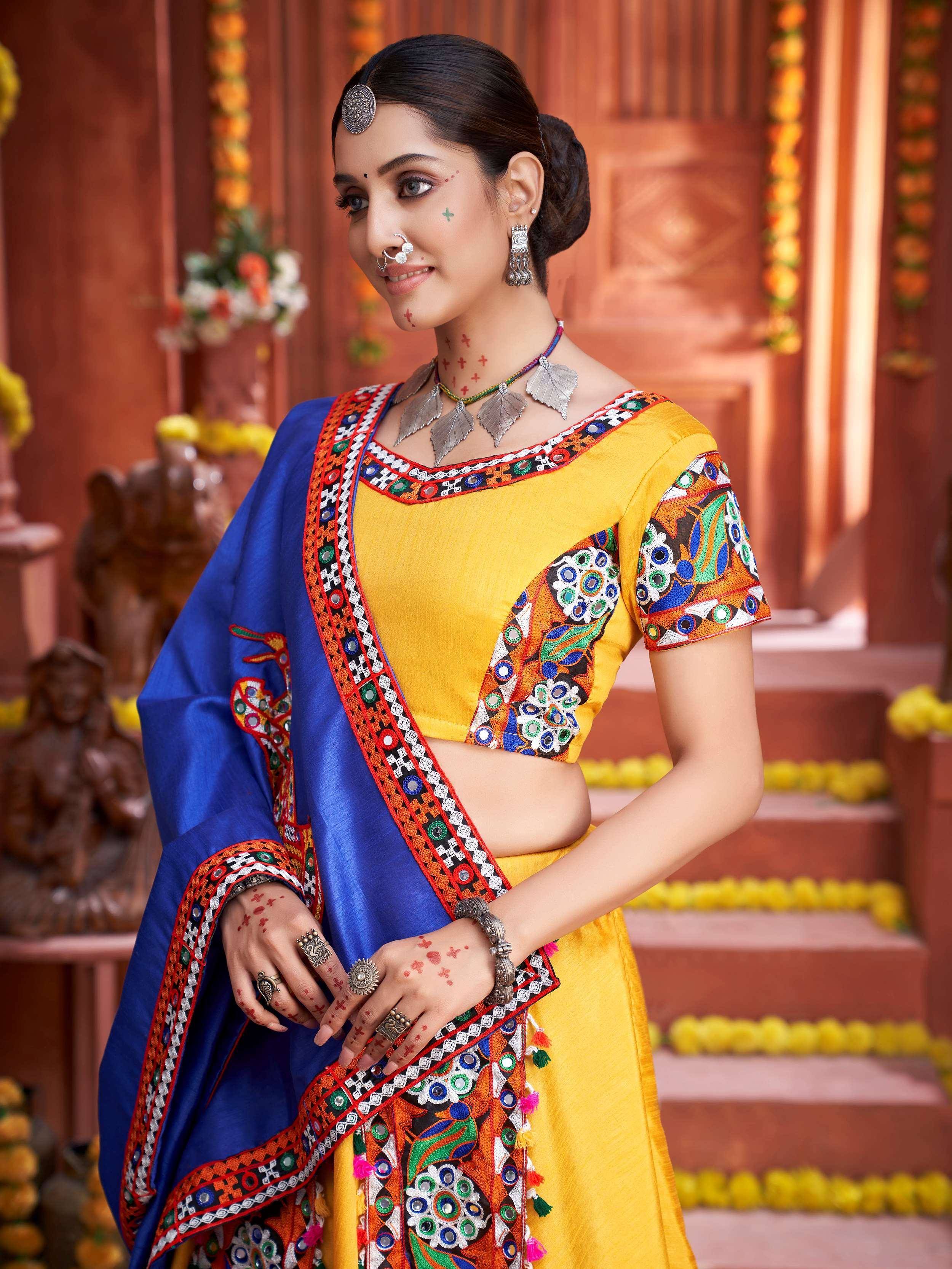 Yellow and blue embroidered ethnic lehenga choli with mirror work, perfect for Indian festivals and weddings.