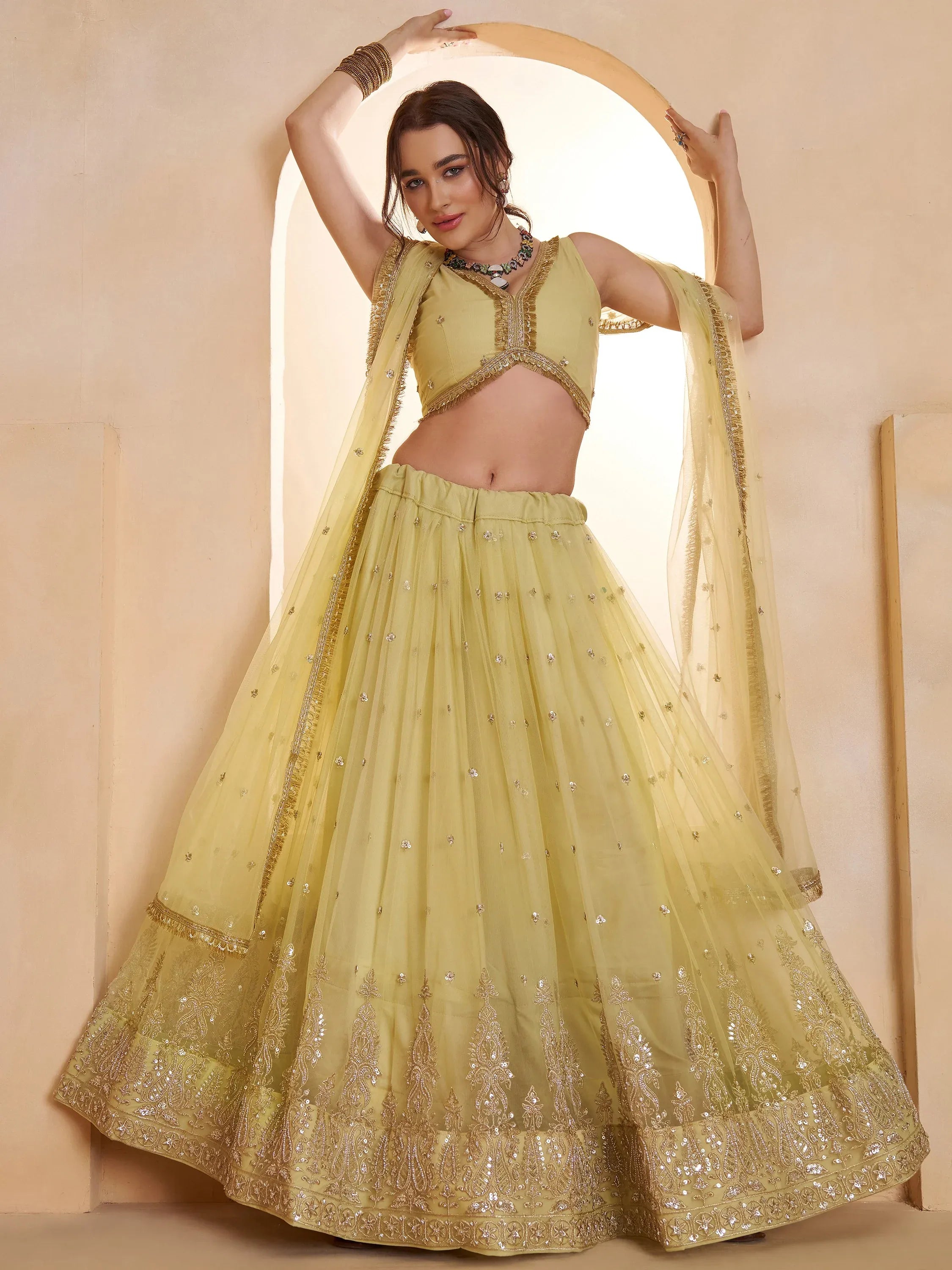 Wonderful Pastel Yellow Embroidered Net Haldi Wear Lehenga Choli