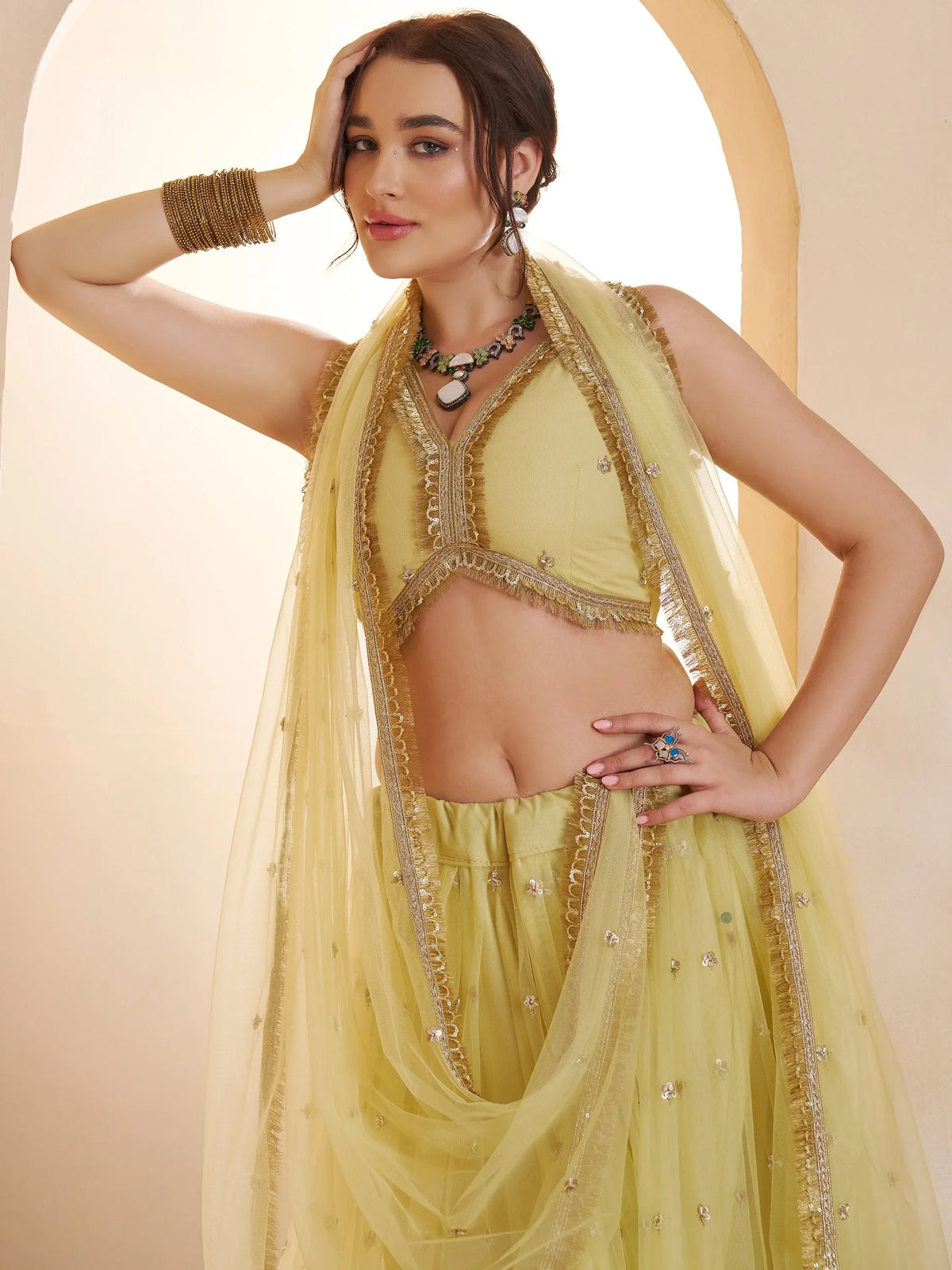 Wonderful Pastel Yellow Embroidered Net Haldi Wear Lehenga Choli