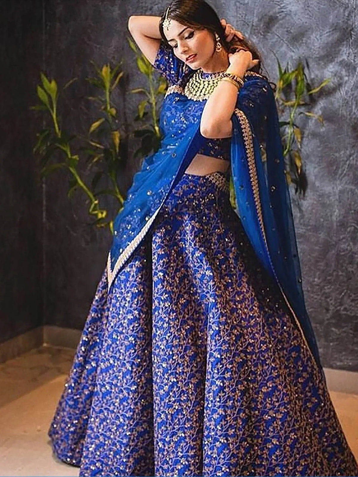 Royal blue designer lehenga choli with gold embroidery and sequins, perfect for weddings and festive occasions