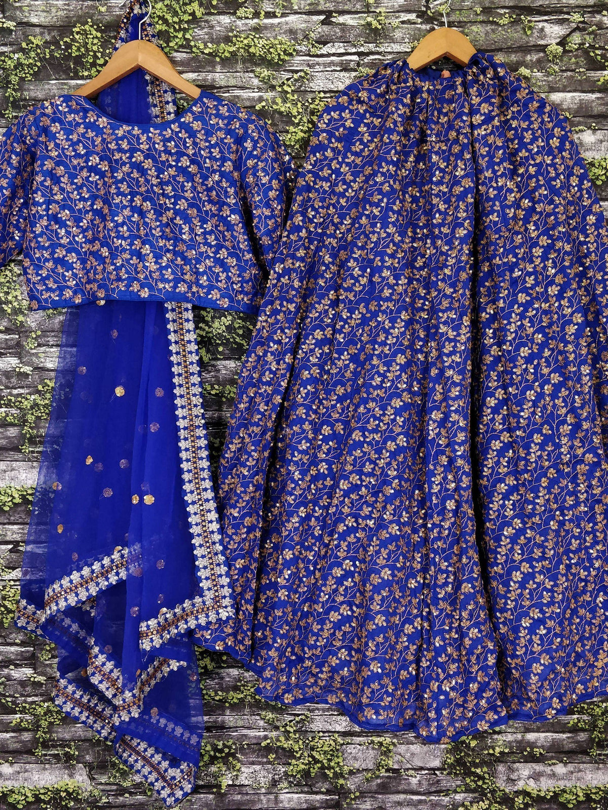 Royal blue embroidered lehenga choli with gold floral motifs, perfect for Indian ethnic wear occasions