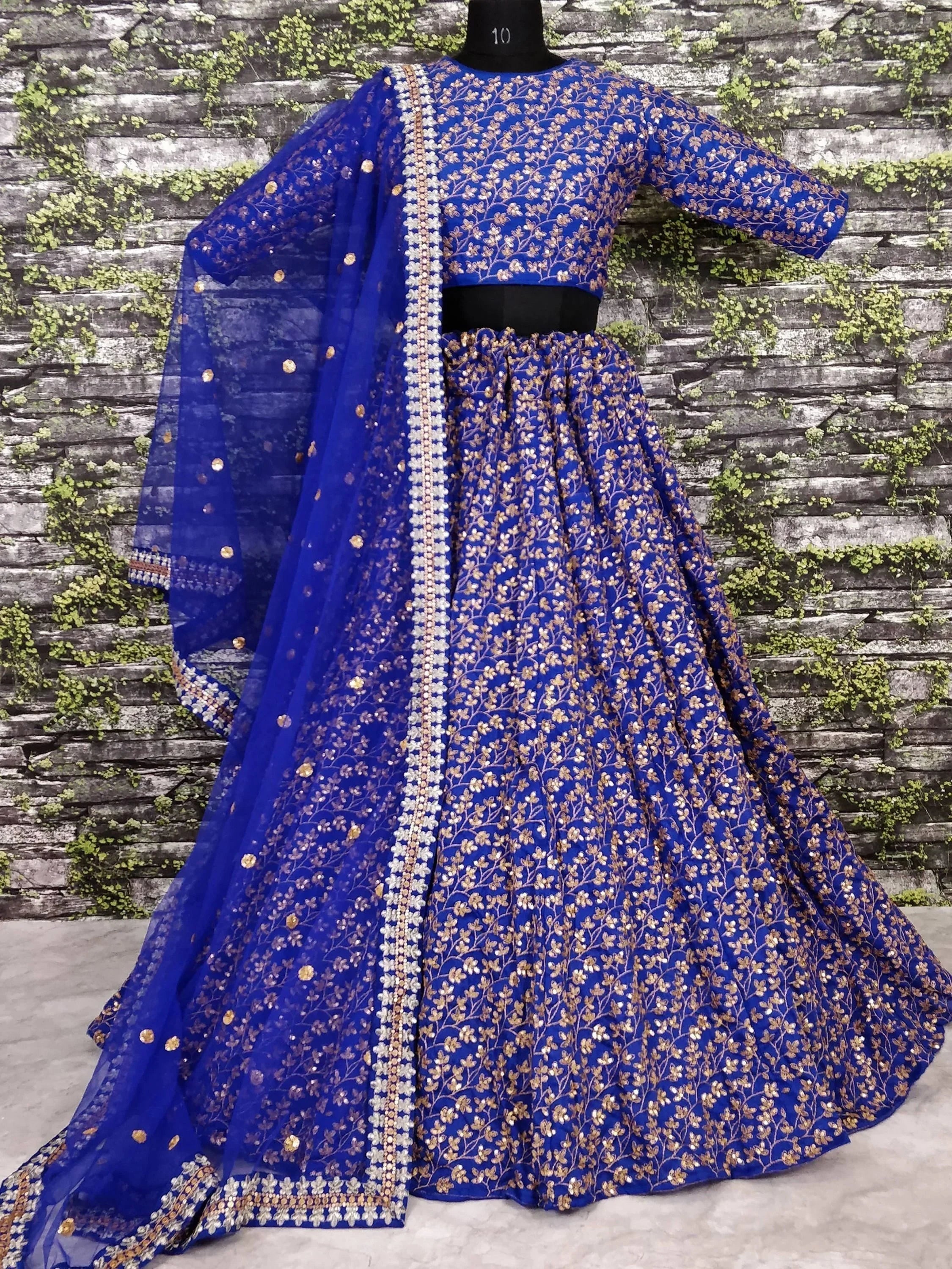 Royal blue embroidered lehenga choli with gold floral work and matching dupatta, perfect for Indian ethnic occasions.
