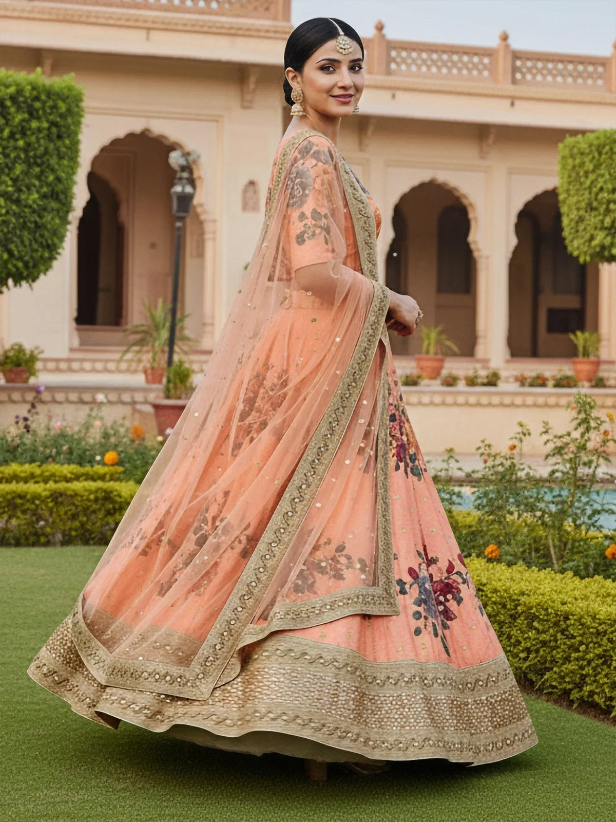 Woman in peach floral lehenga choli with gold embroidery, perfect for Indian weddings and festive occasions.