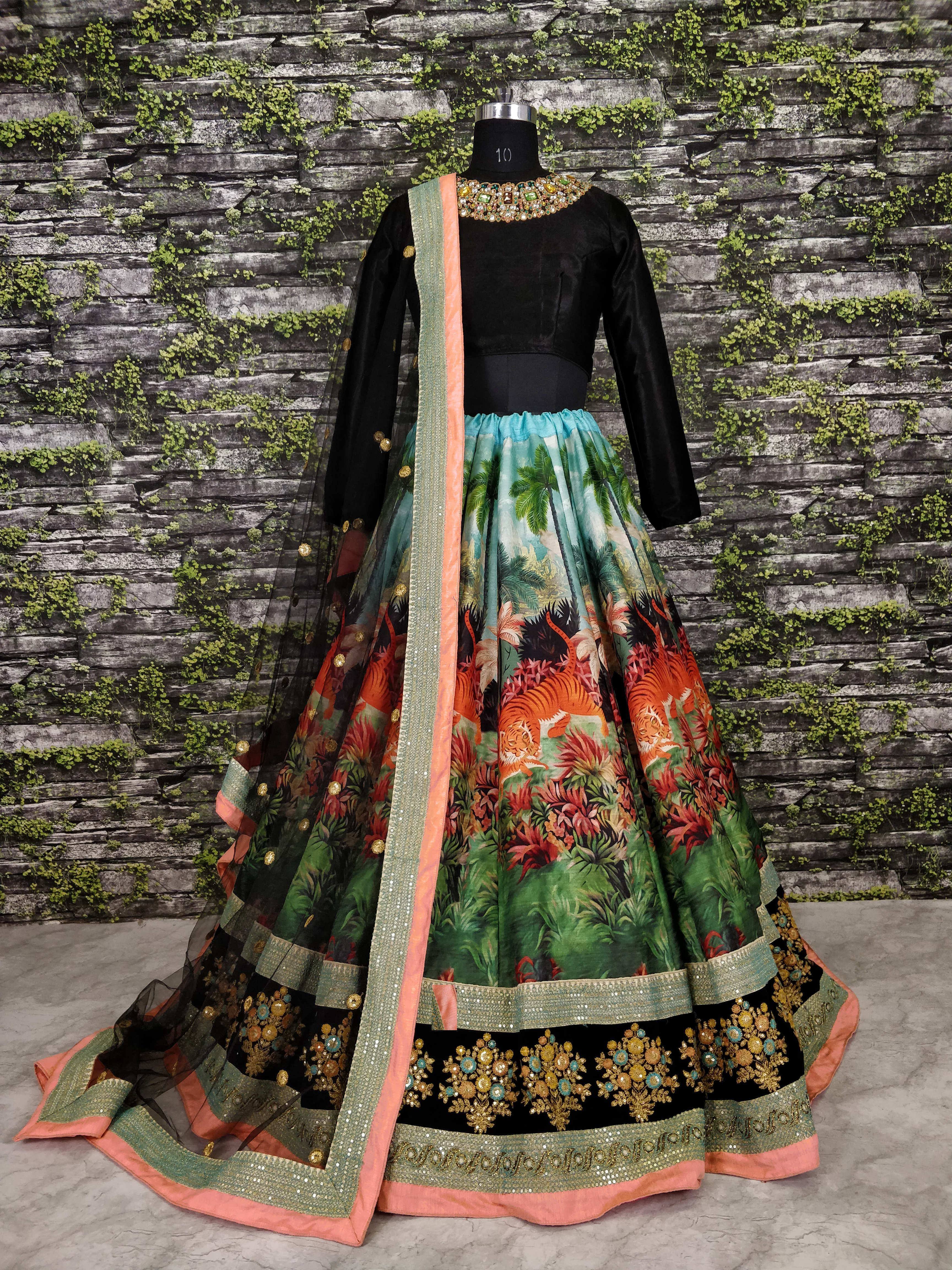 Black velvet lehenga with jungle tiger print skirt, embroidered border, and dupatta, displayed on mannequin
