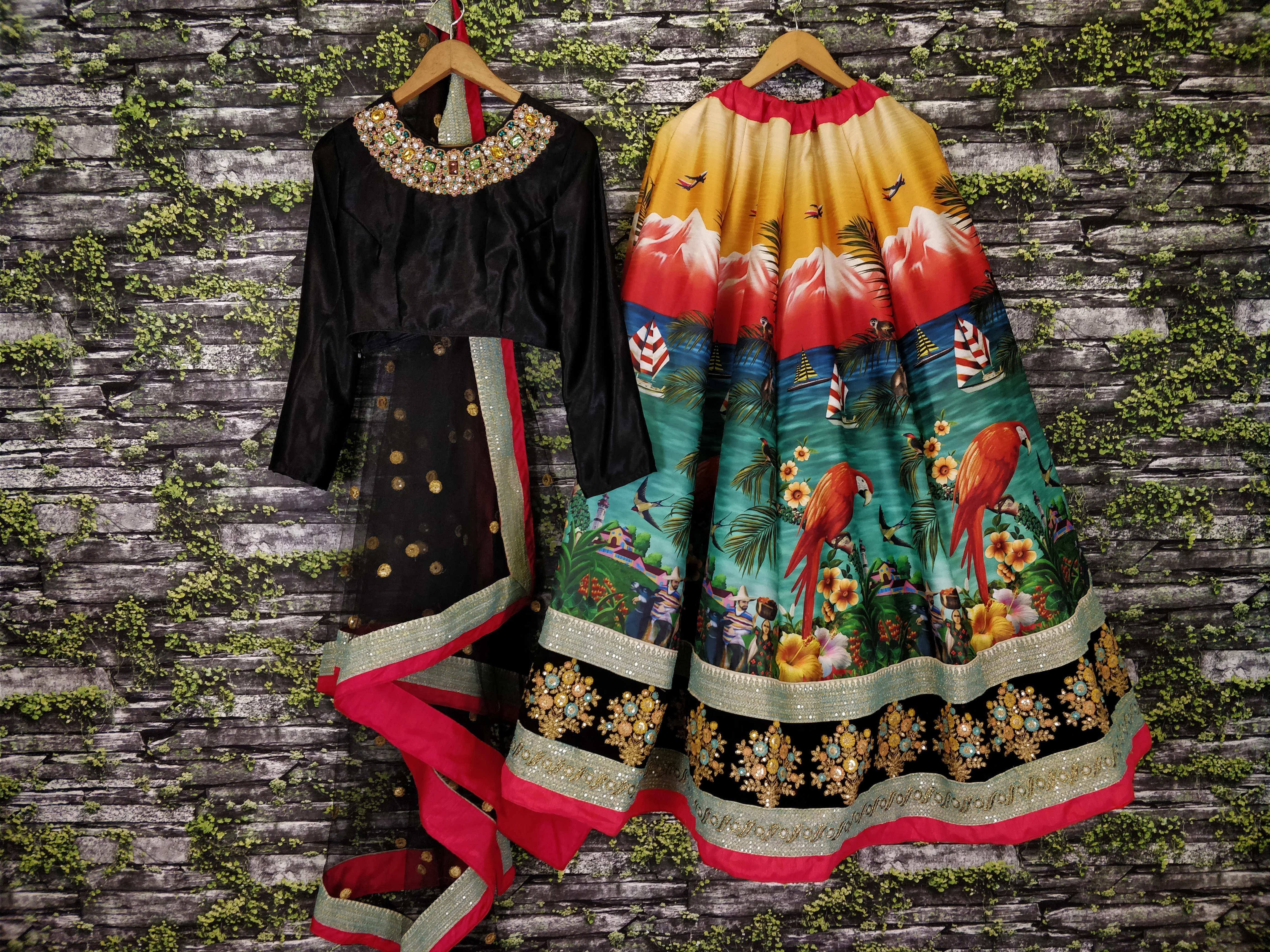 Black and colorful printed ethnic gown with embellished neckline and hem, perfect for festive occasions.