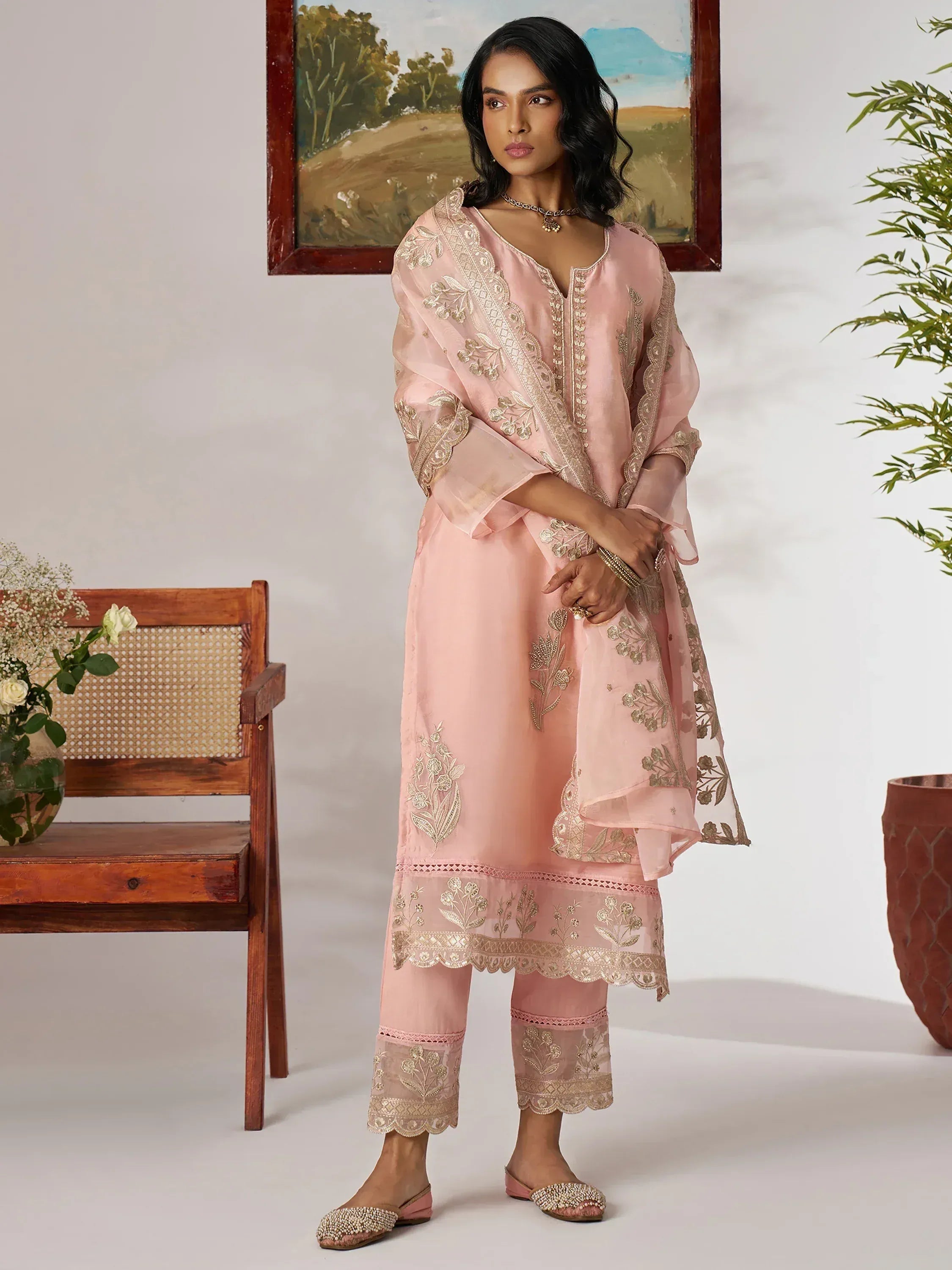Pink embroidered salwar kameez with gold floral detailing, perfect for ethnic occasions