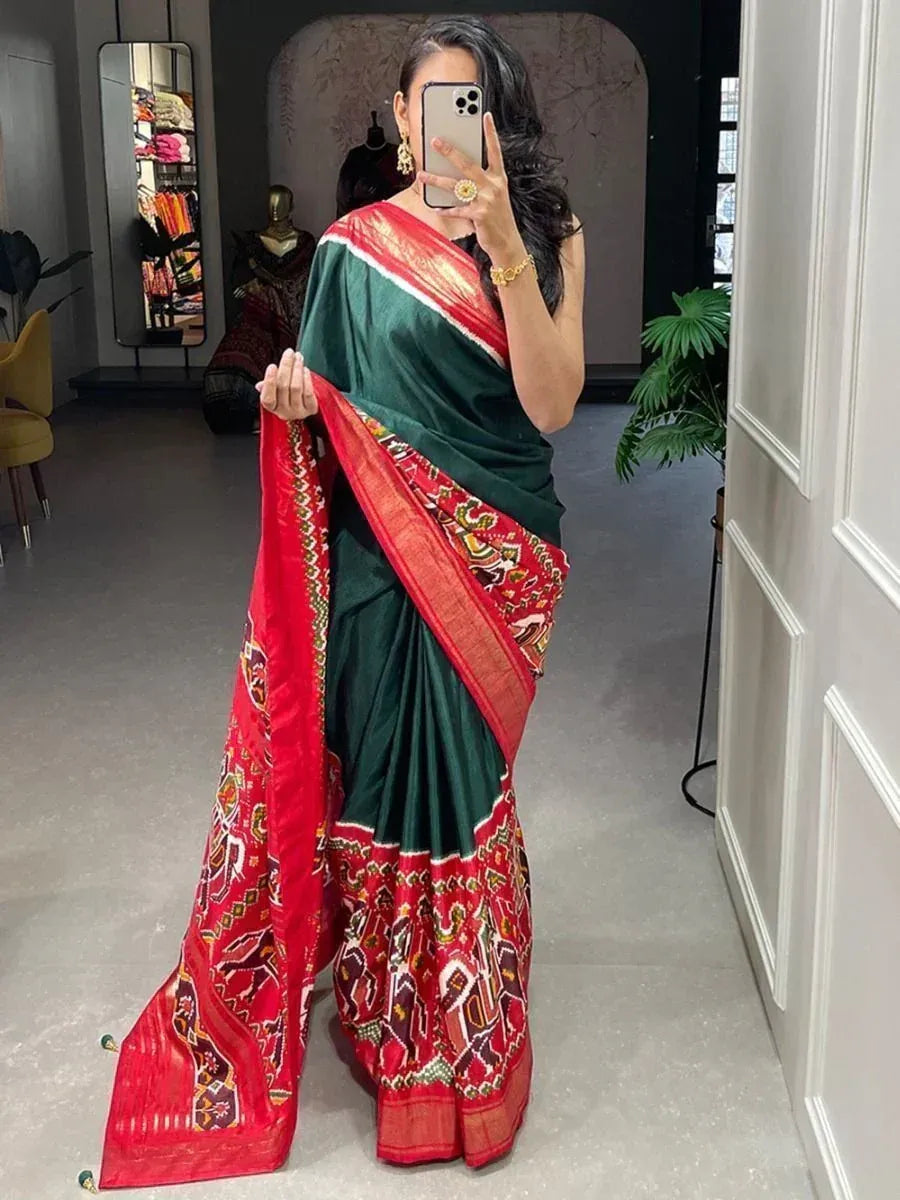 Green and red ethnic saree with intricate border patterns, perfect for Indian occasions