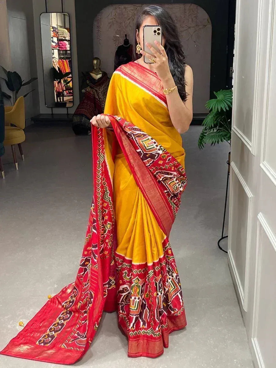 Yellow and red printed saree with ethnic motifs, perfect for Indian occasions and festive wear.