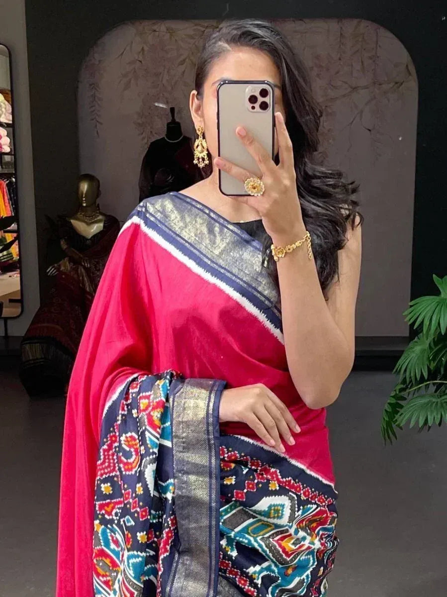 Vibrant pink and blue patterned saree with gold jewelry, perfect for Indian ethnic wear