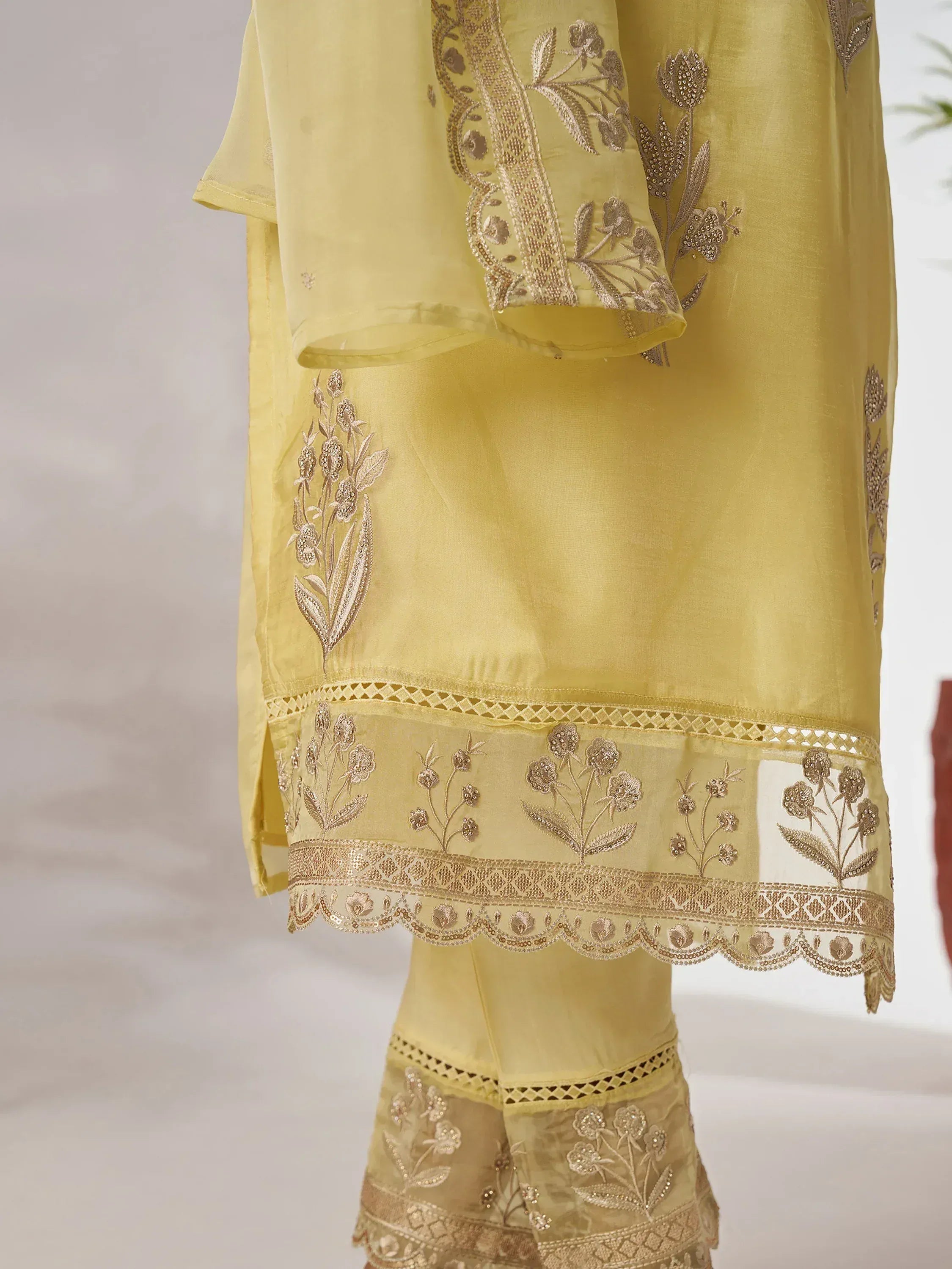 Yellow ethnic salwar kameez with gold floral embroidery and lace detailing for women