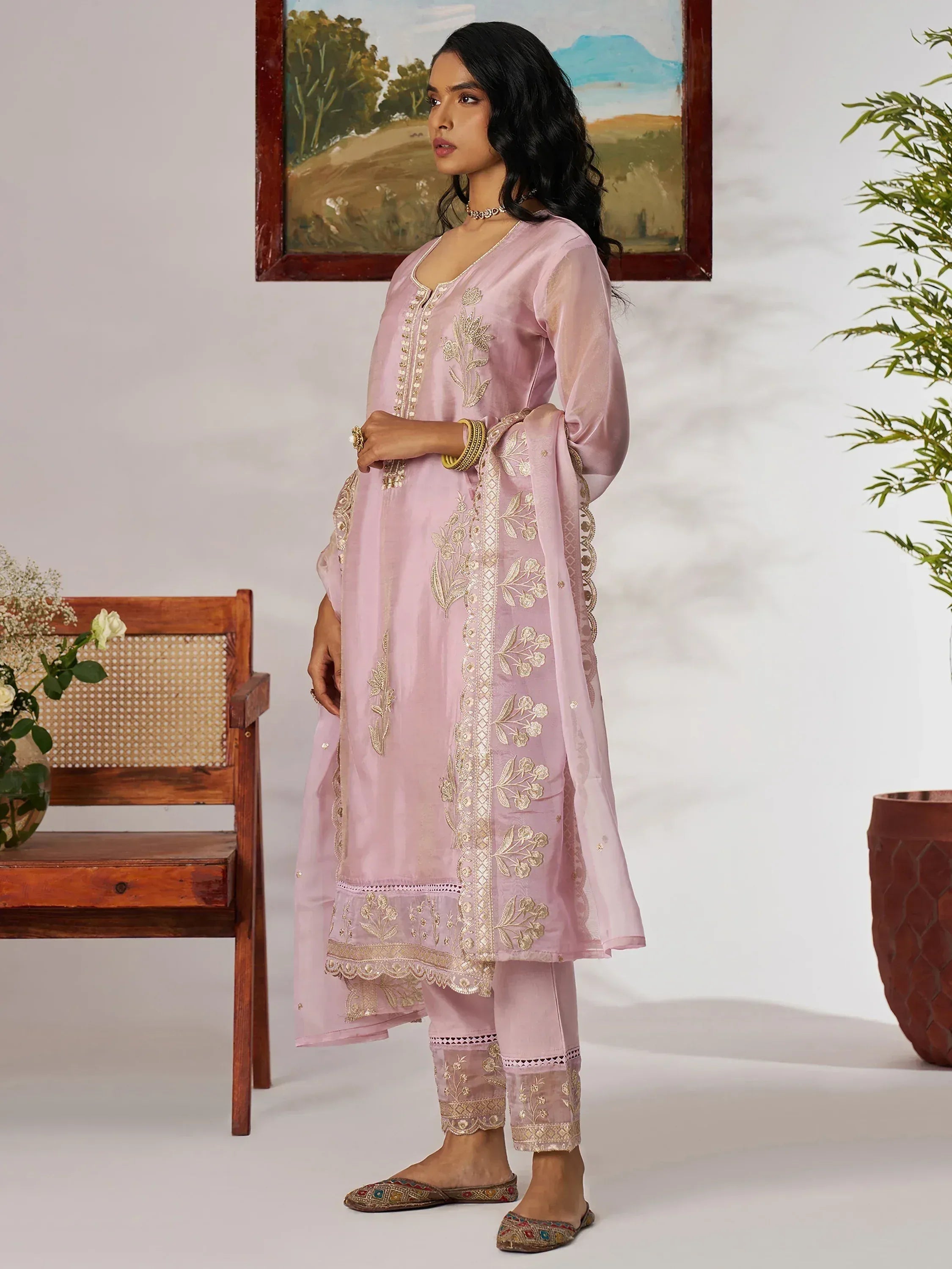 Pink embroidered salwar kameez with gold floral detailing, perfect for ethnic occasions