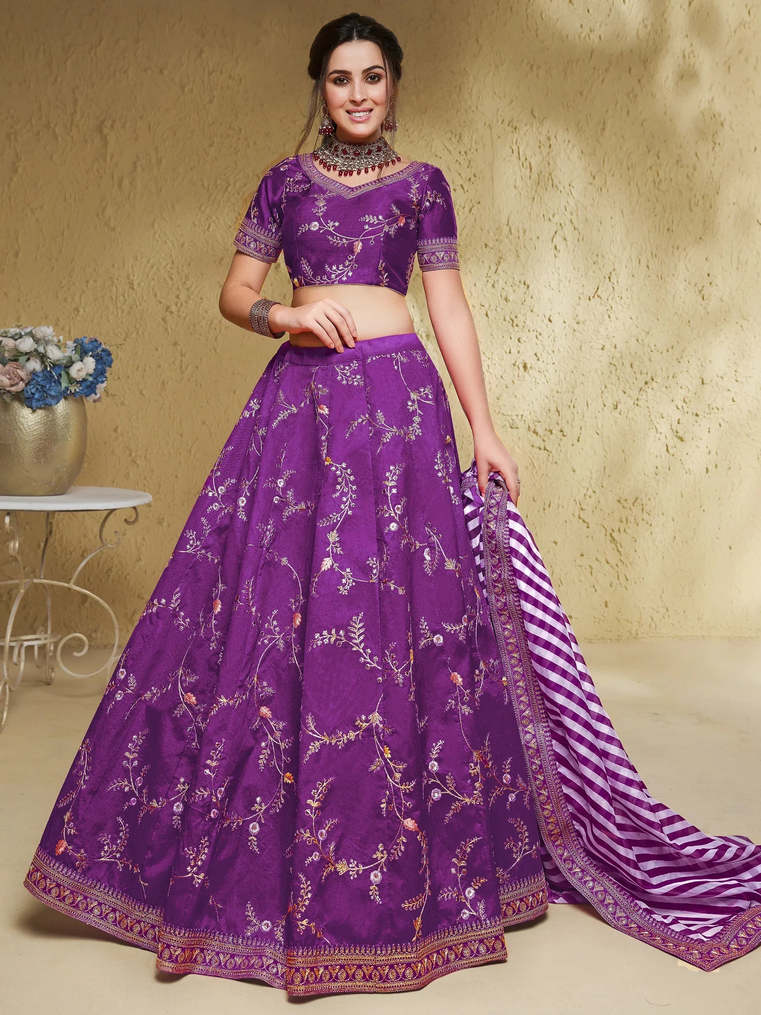 Purple embroidered lehenga choli with floral motifs and striped dupatta, perfect for Indian ethnic wear occasions.