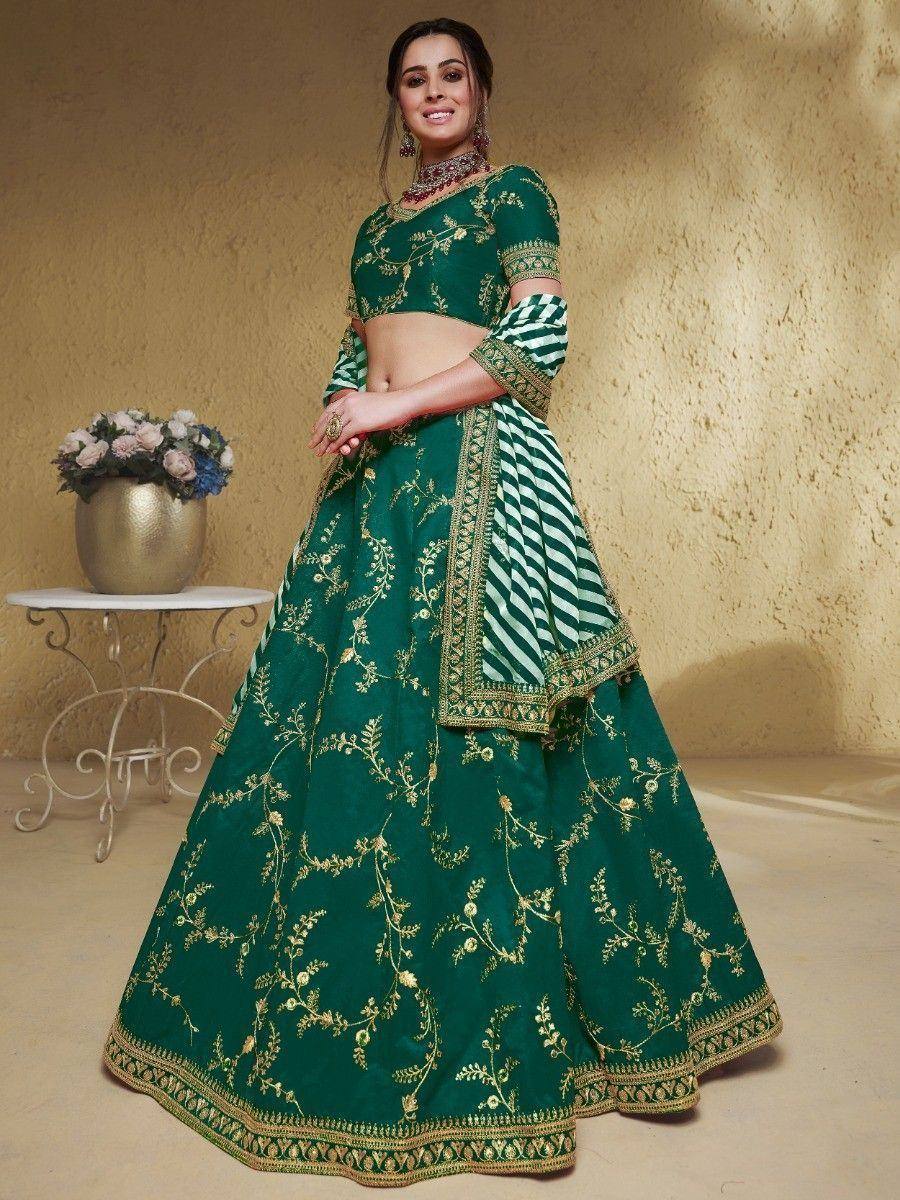 Emerald green lehenga choli with gold floral embroidery and striped dupatta, perfect for Indian weddings and festive occasions.
