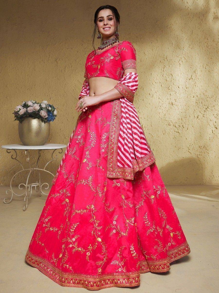 Vibrant pink embroidered lehenga choli with gold floral motifs and striped dupatta, perfect for Indian ethnic occasions.