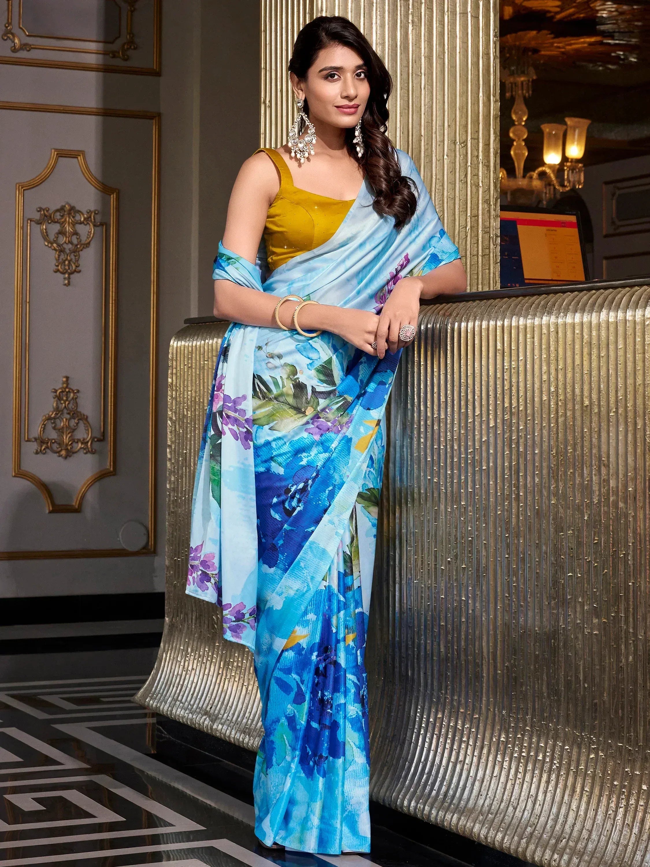 Woman in blue floral printed saree with yellow blouse, elegant ethnic wear for parties