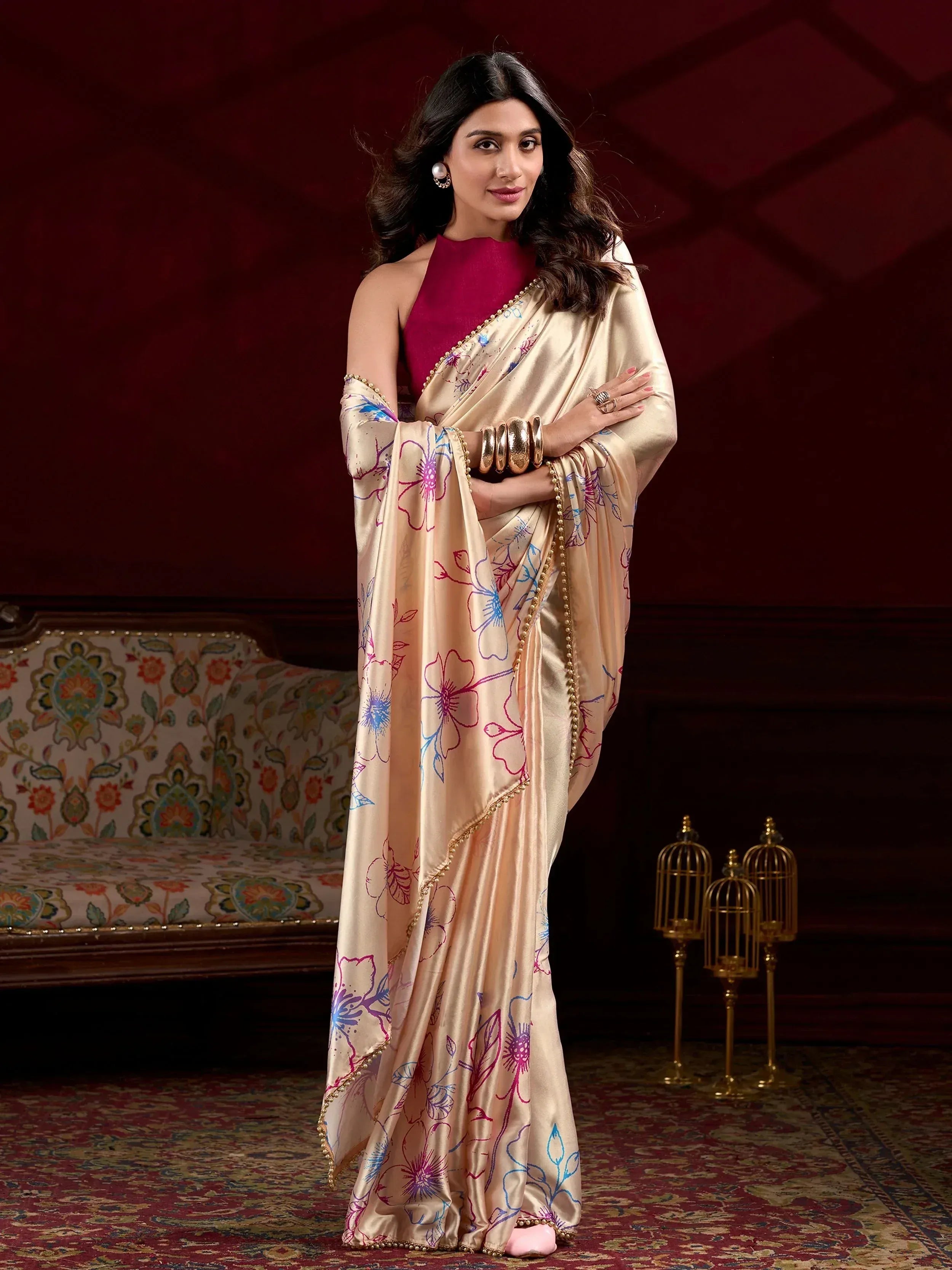 Elegant cream saree with floral print and gold border, paired with magenta blouse, perfect for Indian ethnic occasions