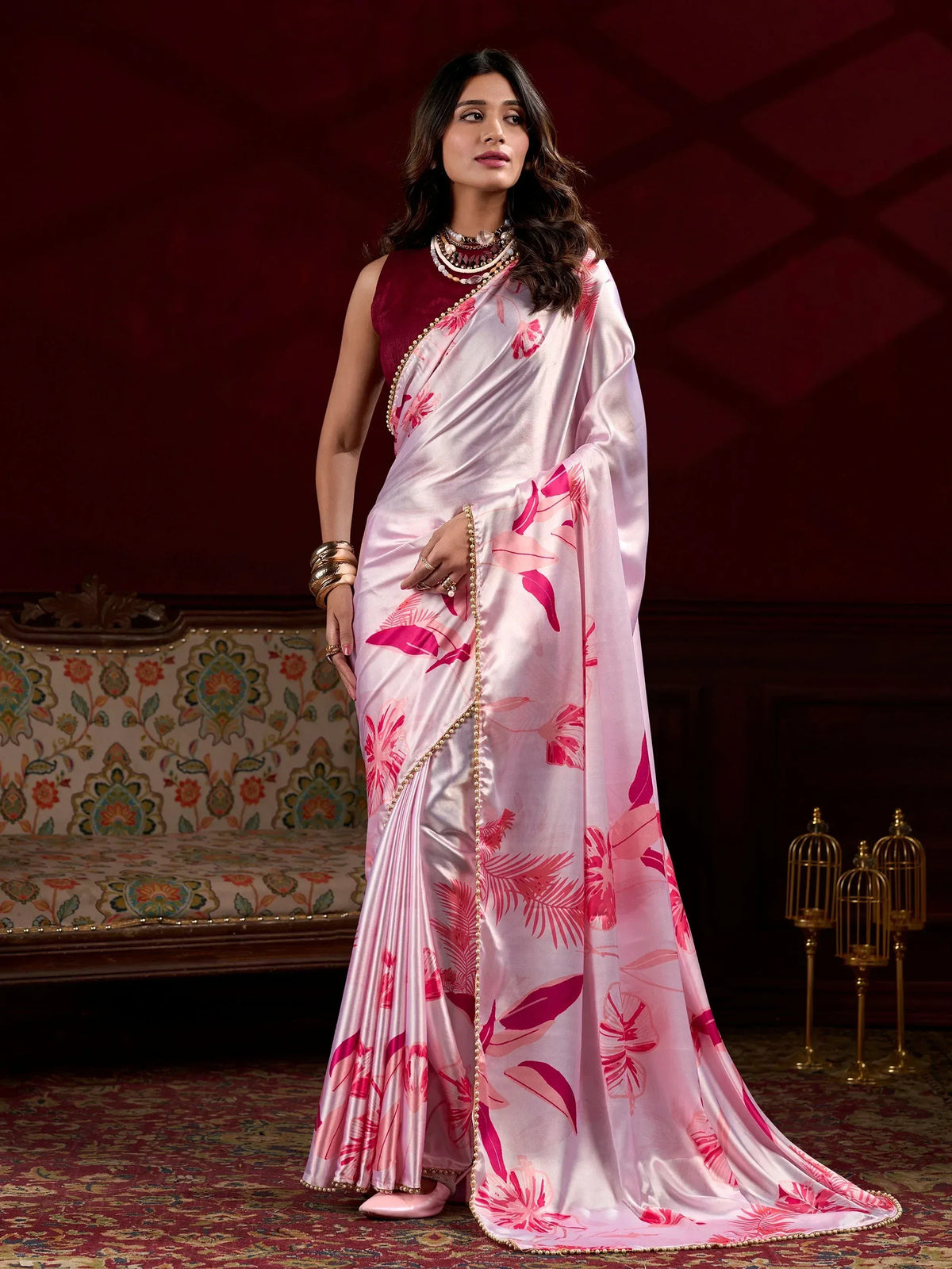 Pink floral print silk saree with gold border, paired with maroon blouse, elegant Indian ethnic wear