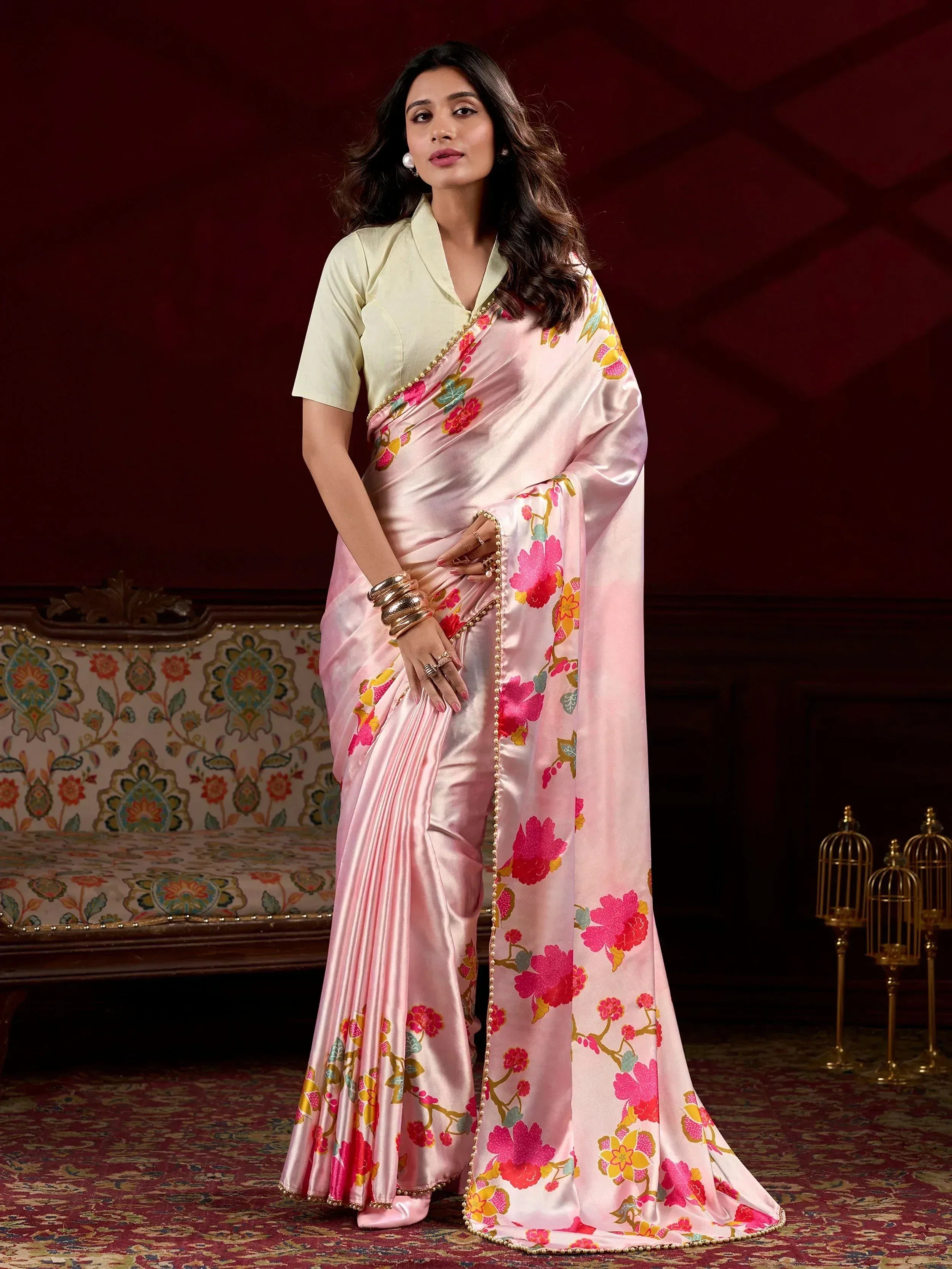 Pink floral satin saree with gold border, paired with light yellow blouse, perfect for Indian ethnic occasions