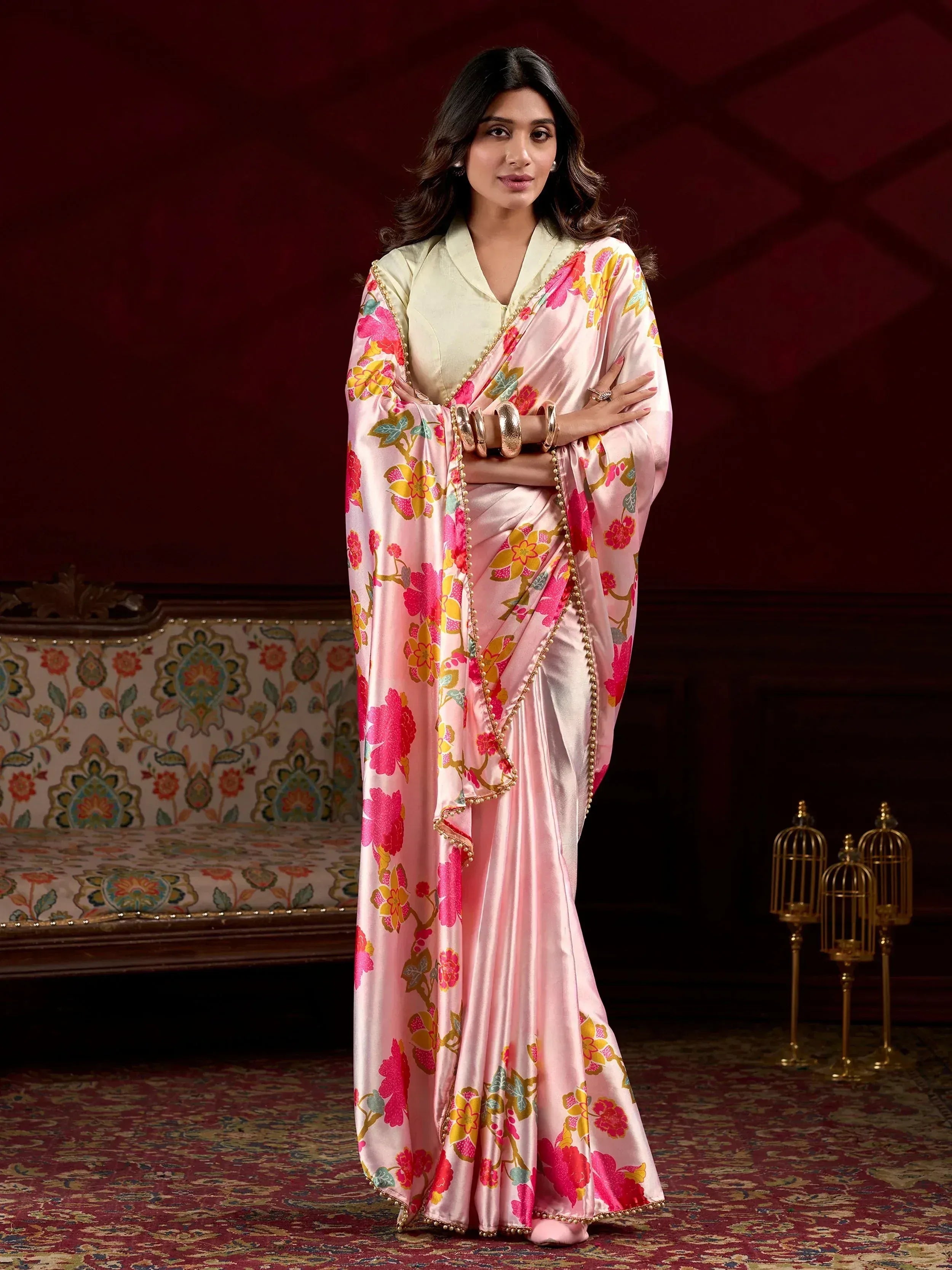 Pink floral saree with gold trim, paired with light green blouse, elegant Indian ethnic wear