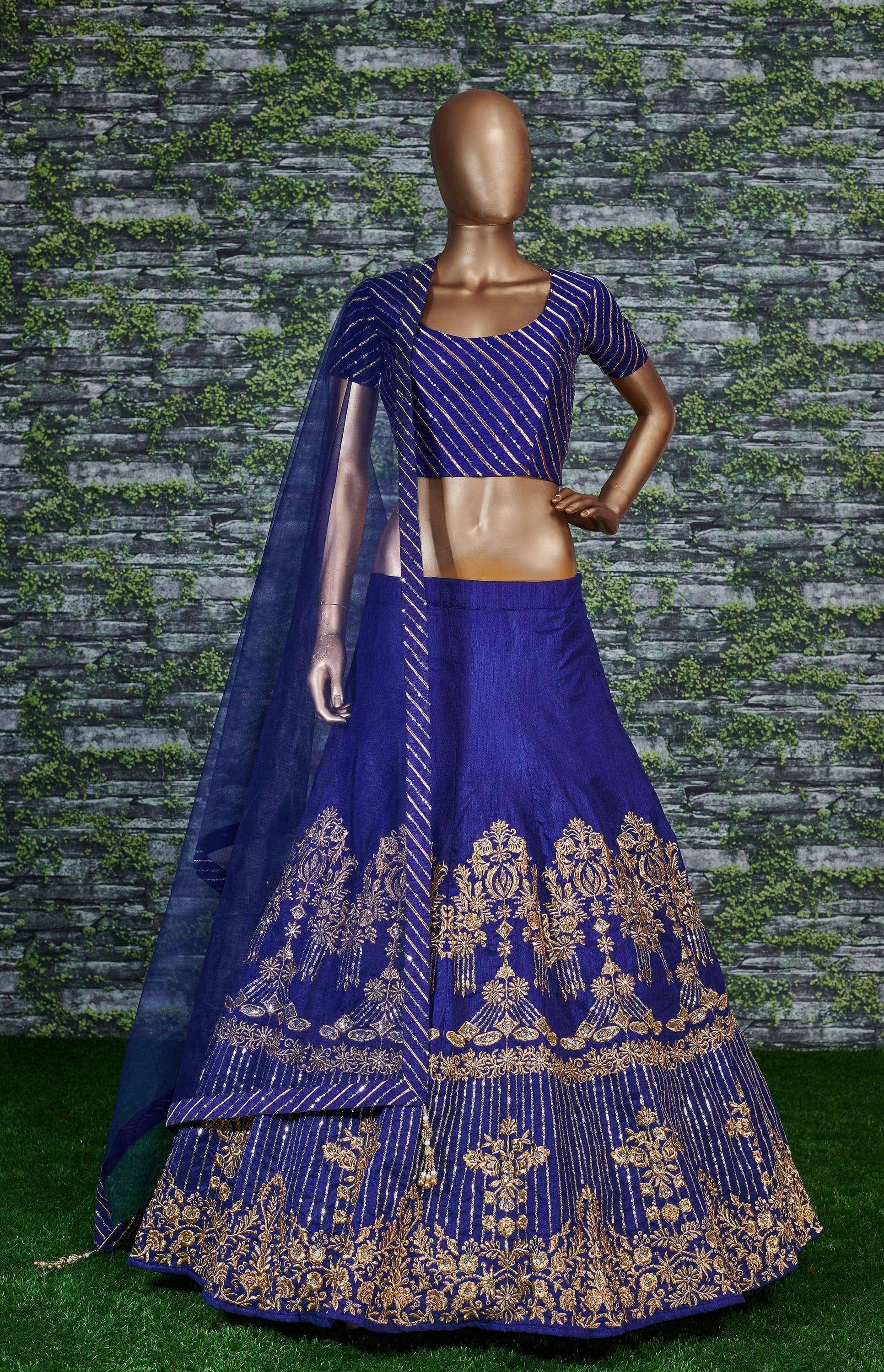 Royal blue lehenga choli with gold embroidery, perfect for Indian weddings and festive occasions.