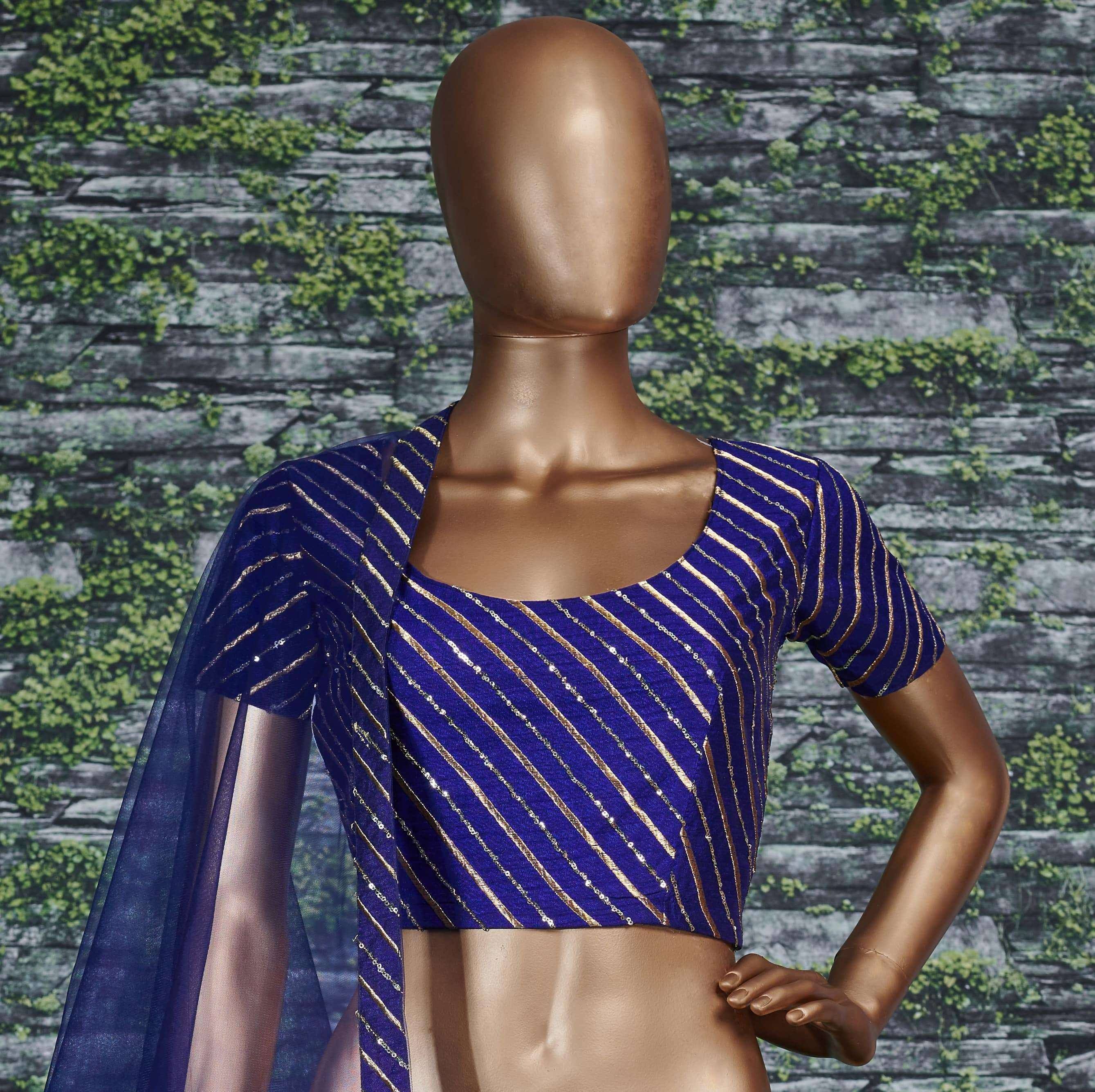 Royal blue ethnic blouse with gold diagonal stripes and sheer cape, displayed on mannequin