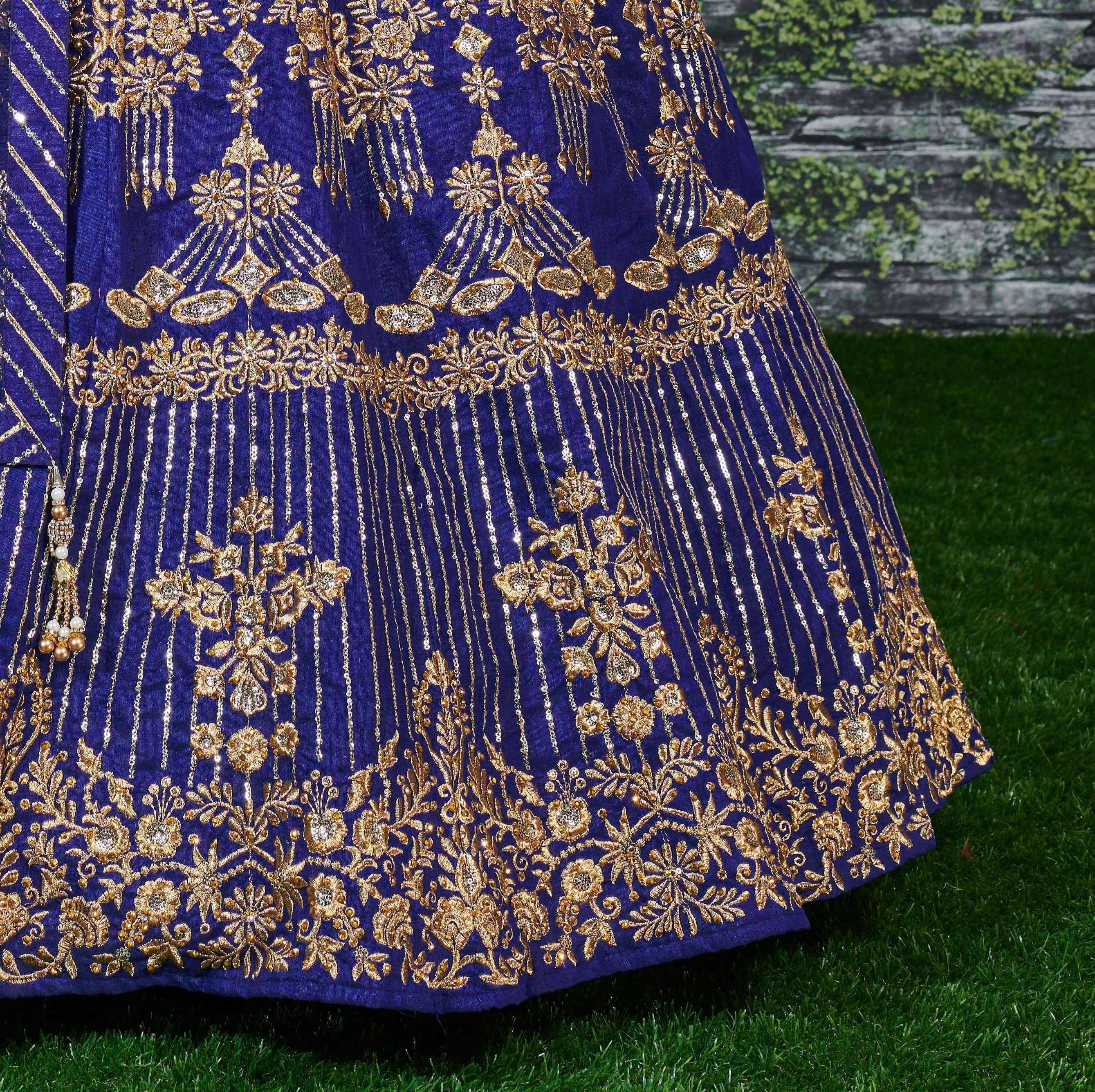 Royal blue lehenga with intricate gold embroidery and sequin detailing, perfect for Indian weddings and festive occasions.
