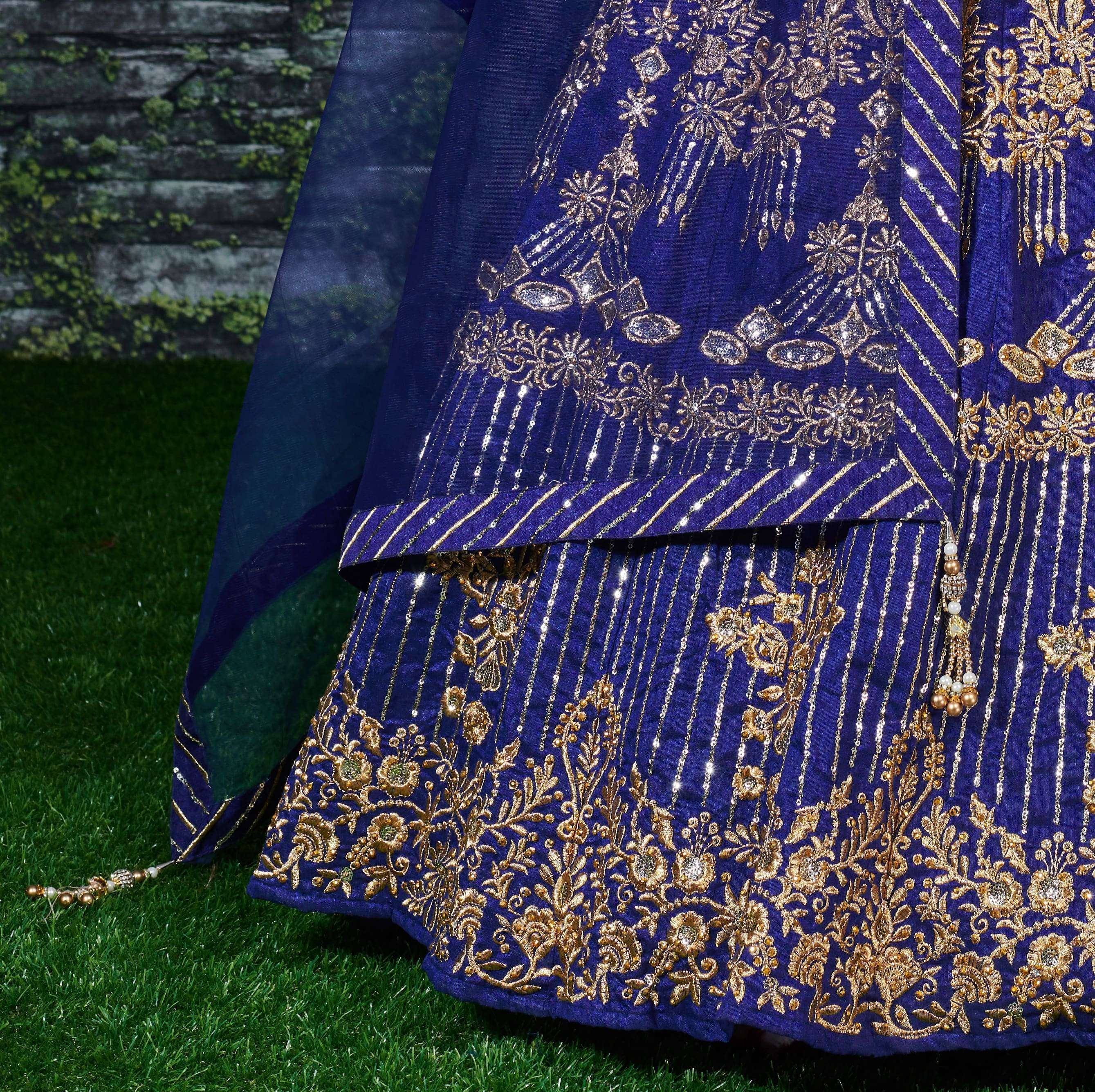 Royal blue ethnic lehenga with gold floral embroidery and sequin detailing, perfect for Indian weddings and festivals.