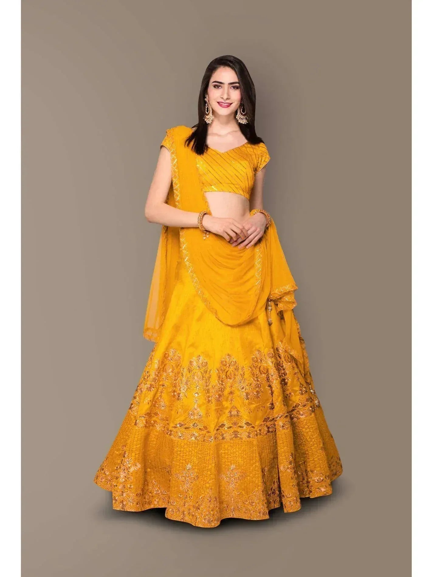 Yellow designer lehenga choli with gold embroidery, perfect for Indian ethnic wear and festive occasions.
