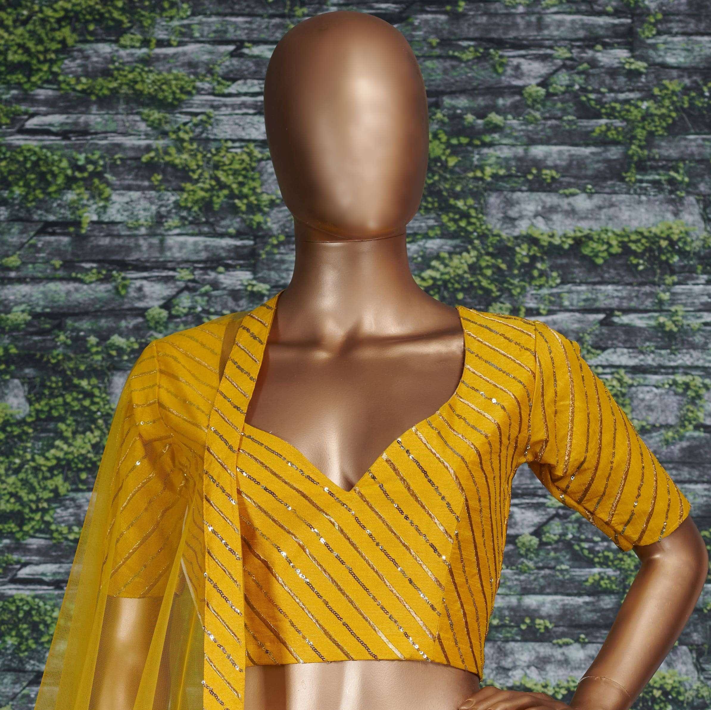 Yellow ethnic blouse with gold stripes and sequins, styled with sheer dupatta for Indian wear
