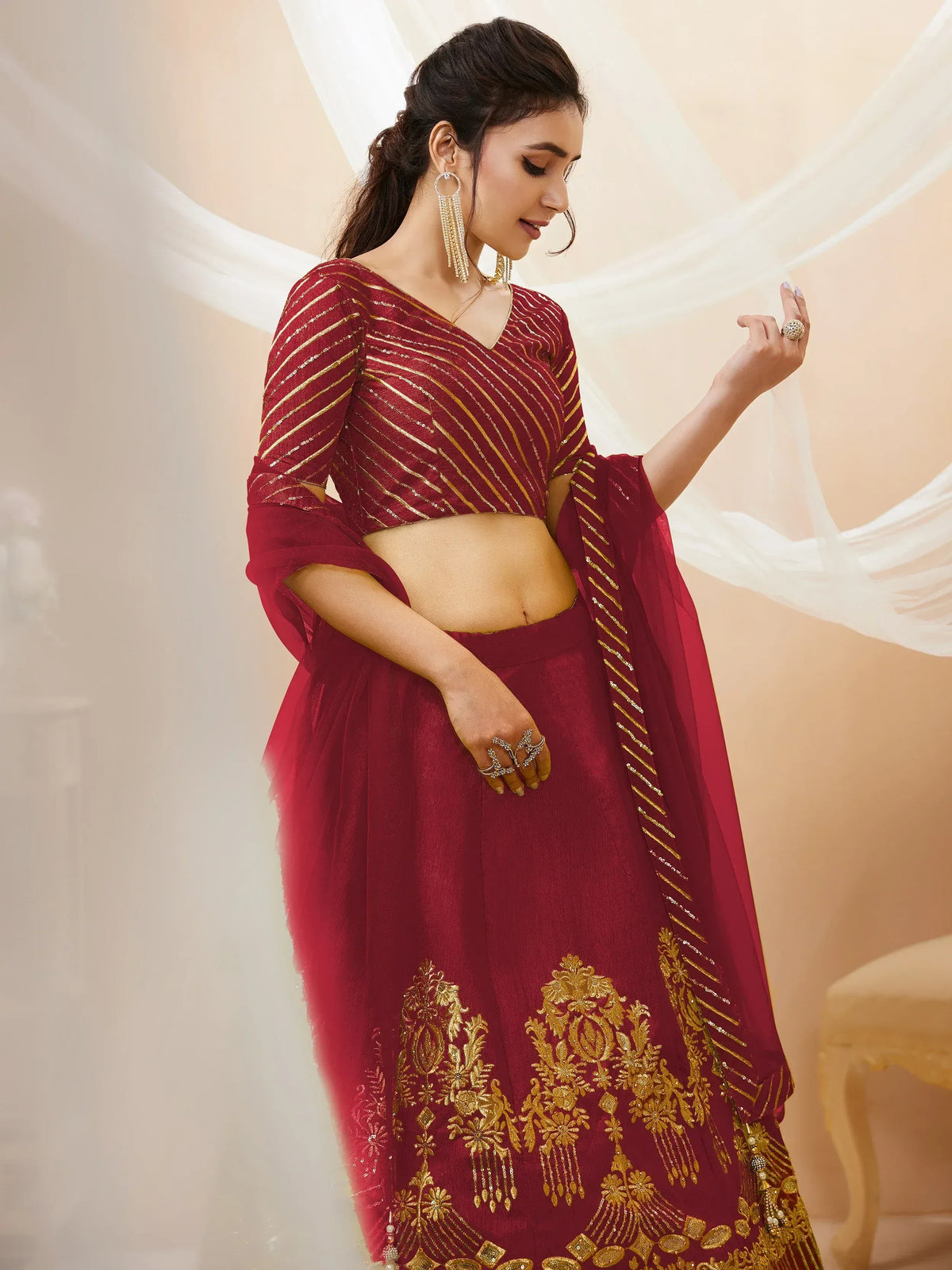Maroon lehenga choli with gold embroidery and striped blouse, perfect for Indian ethnic wear