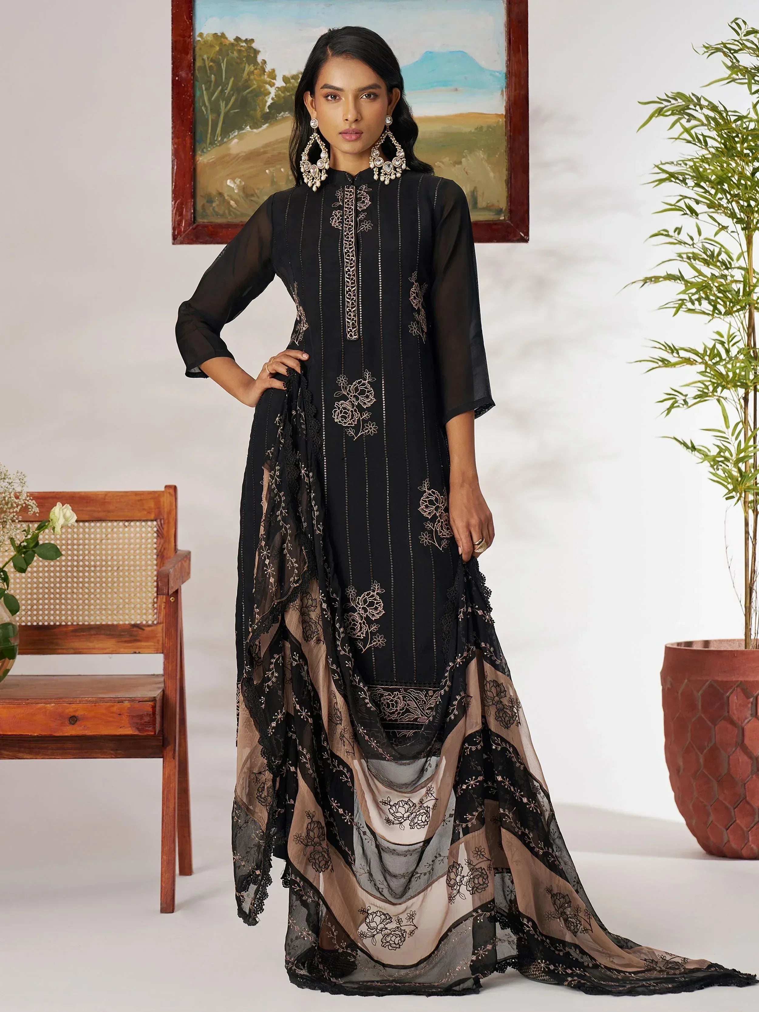 Black embroidered ethnic gown with sheer overlay and floral detailing, perfect for Indian festive wear.