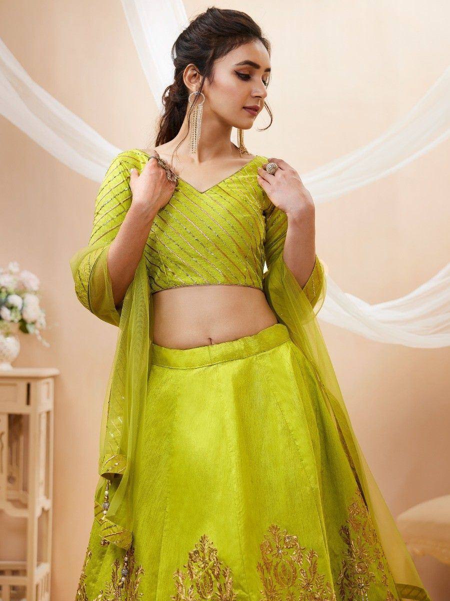 Lime green designer lehenga choli with gold embroidery and sheer dupatta, perfect for Indian ethnic occasions